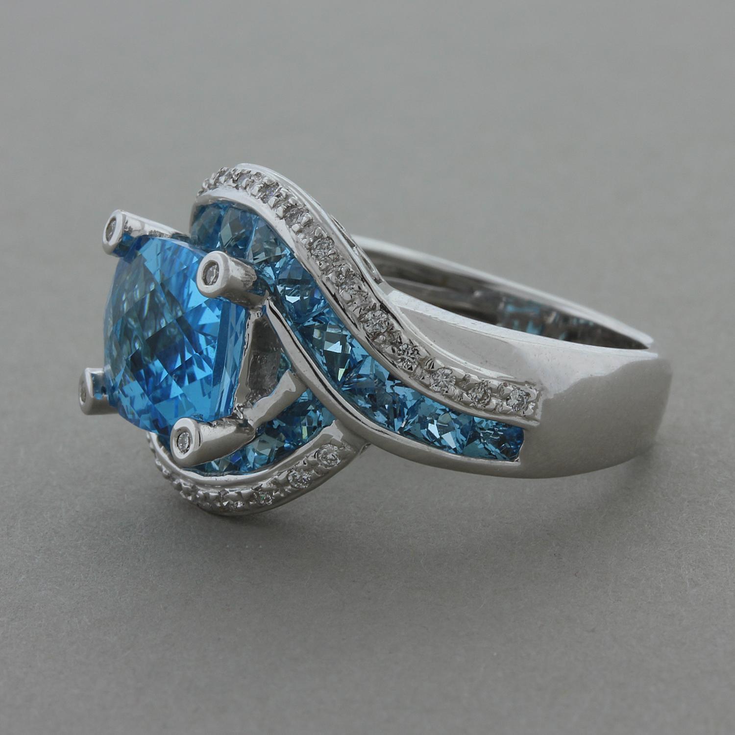 This Bellarri ring is a vacation in itself with its dreamy ocean blue topaz. The ring features 7.76 carats of blue topaz which are accented by 0.24 carats of round cut diamonds. The two swirls of this 18K white gold ring hugging the center blue