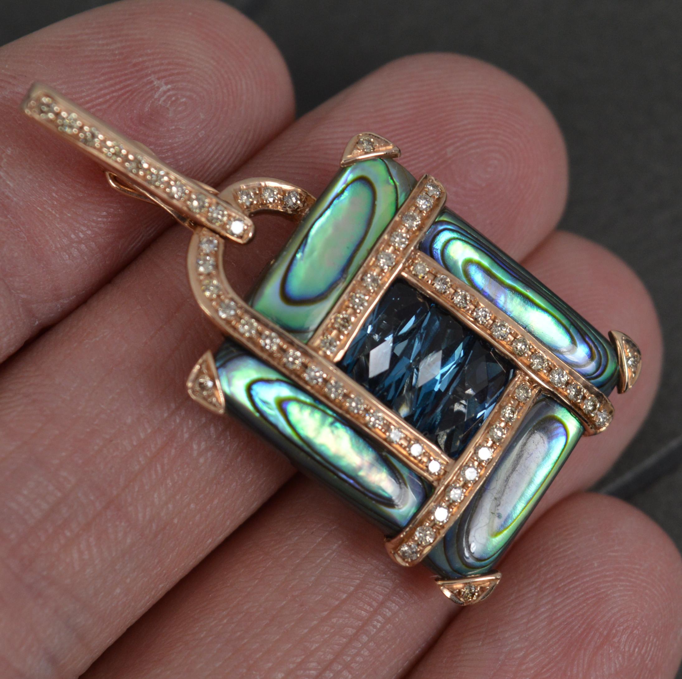 A superb designer pendant by Bellarri.
Solid 14 carat rose gold piece.
Designed with three facet cut rectangular shaped topaz stones to centre. Four abalone shell panels surrounding and all gold sections pave set with round brilliant cut