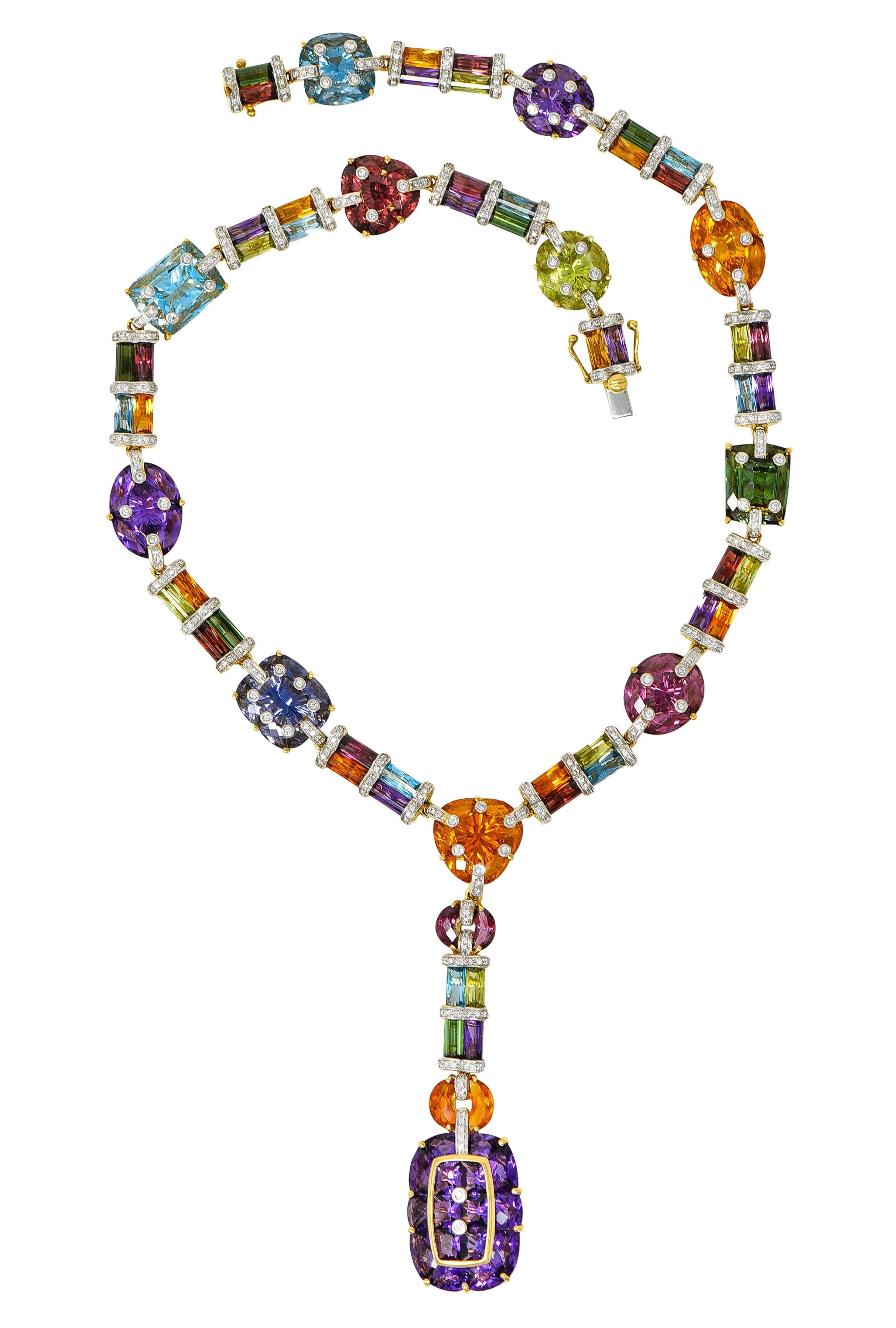 Yellow gold collar necklace is comprised of fancily cut gemstone cluster stations alternating with barrel cut gemstone spacer links. Featuring brightly colored citrine, garnet, amethyst, peridot, green tourmaline, iolite, and others. With an
