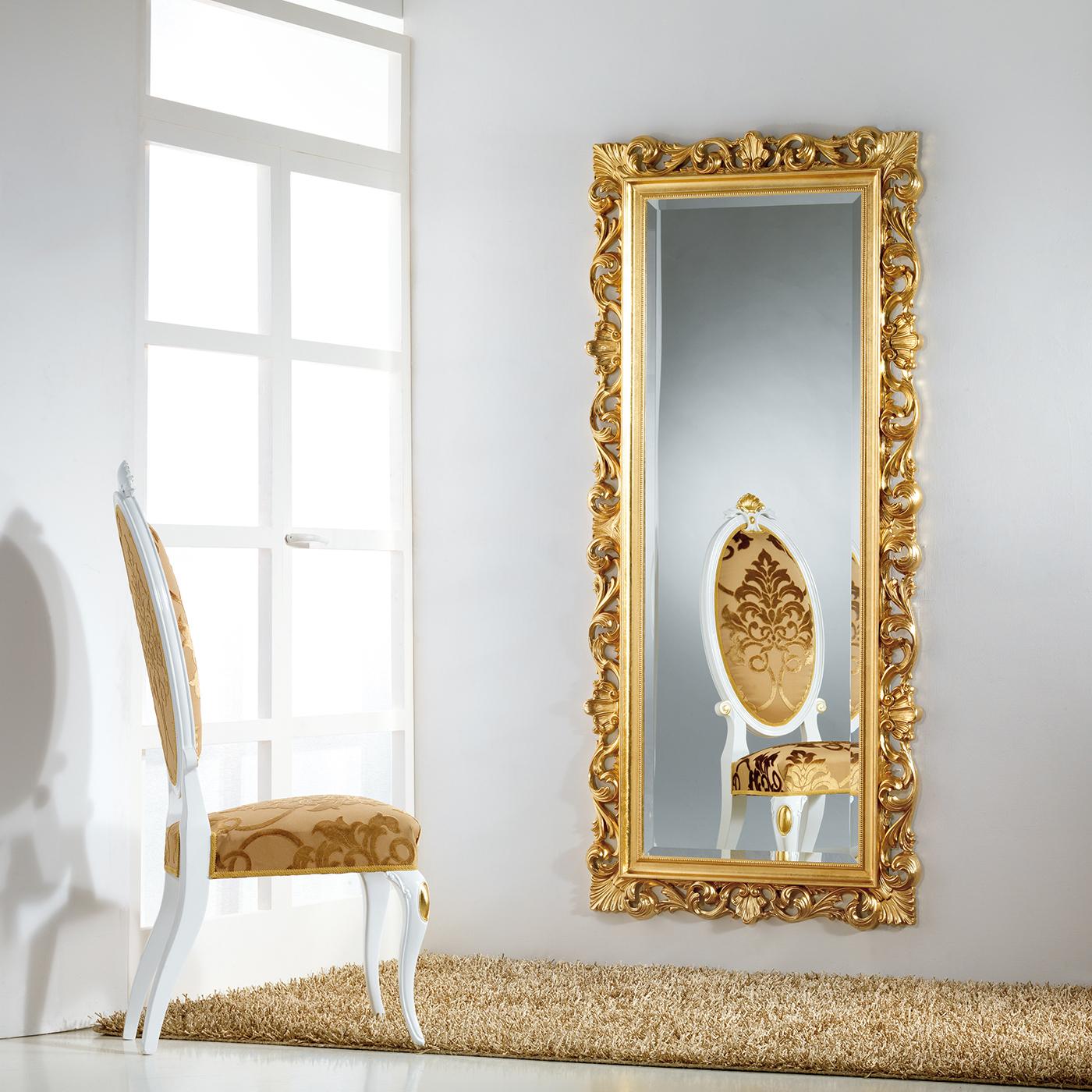 Featuring a rectangular, beveled mirror in prized Italian crystal, this sophisticated wall mirror will be an eye-catching addition to a refined interior. The bold Baroque frame is crafted of wood and adorned by hand with gold leaf, highlighting its