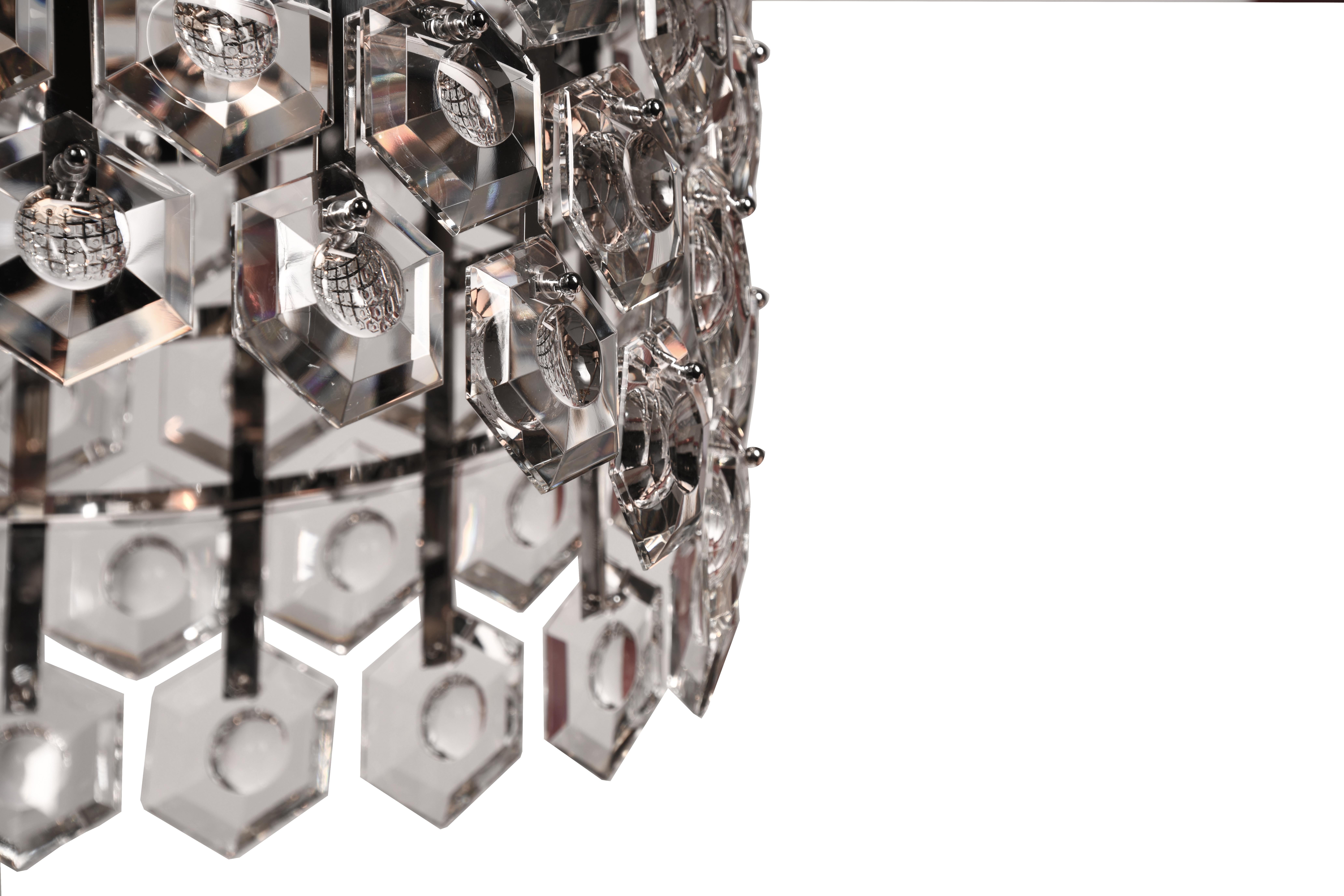 Halos of luxurious crystal hexagons - faceted with a custom carved concave detail - defuse and refract light within and throughout. Elusive and illusory, BELLAZA casts a symphony of light and shadow.

Offered in single and layered double tiers with