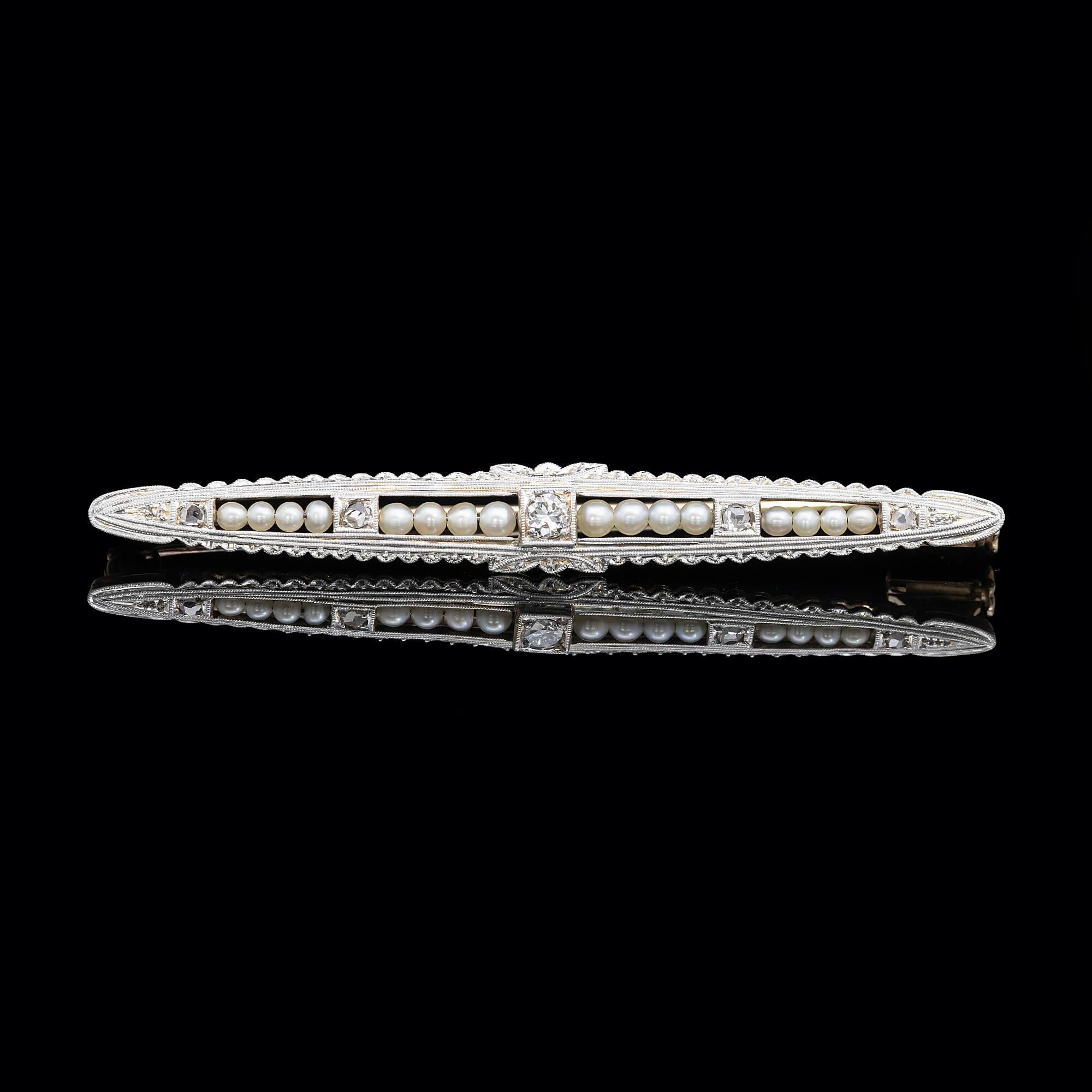 A superbly made French bar brooch set with very fine natural pearls and mixed cut diamonds. Featuring beautiful mille-grained outlines and decorative edging. Secured and fitted with a gold pin and ornate plunger catch.

Gemstone: Sixteen graded very