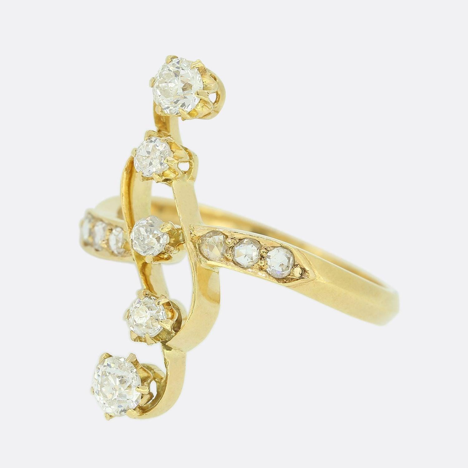 Here we have a gorgeous Belle Époque diamond crossover ring. This continental piece showcases an open structure featuring five old cut diamonds that sit raised and individually claw set atop of one another at the centre of the face. These focal