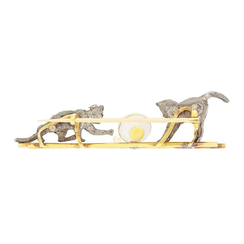 This Antique French cat brooch, dates to the 1880s, Belle Époque period. The brooch features two charming silver cats, each encrusted with grain set rose cut diamonds totalling 0.60 carats, their delicate sparkle lending a whimsical design. The cats