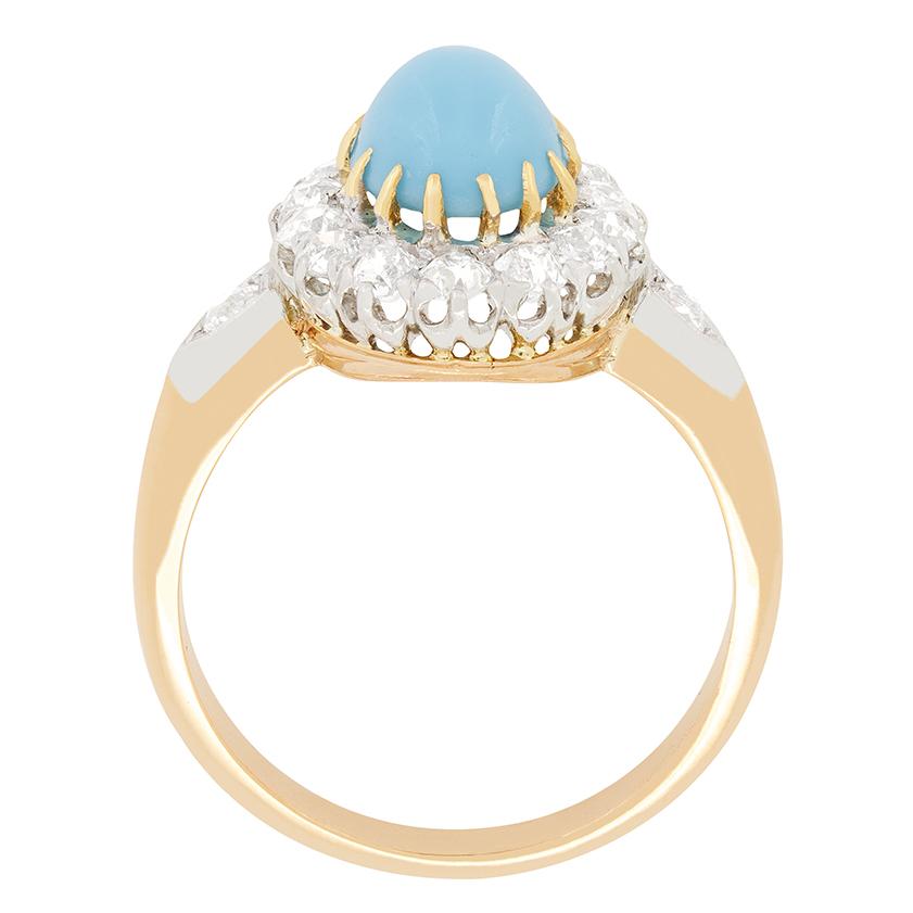 This enchanting turquoise cluster ring dates back to the Belle Époque period of French history. The beautiful cabochon cut stone is 1.20 carat and has been claw set with 18 carat rose gold. Surrounding the turquoise is a halo of old cut diamonds,
