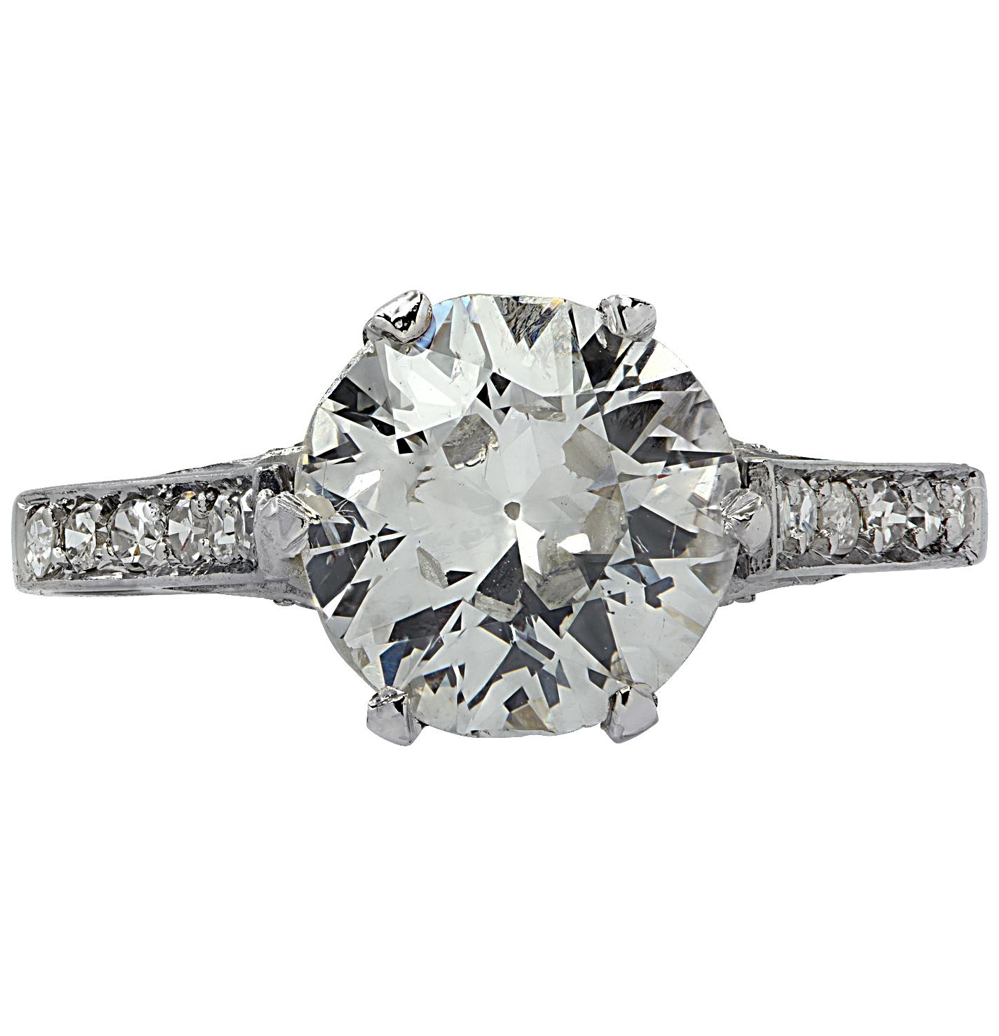 Beautiful Belle Époque engagement ring finely crafted in platinum, showcasing a gorgeous Old European Cut Diamond weighing approximately 1.63 carats, I color, SI clarity adorned with 24 single cut diamonds weighing approximately .36 carats total, I