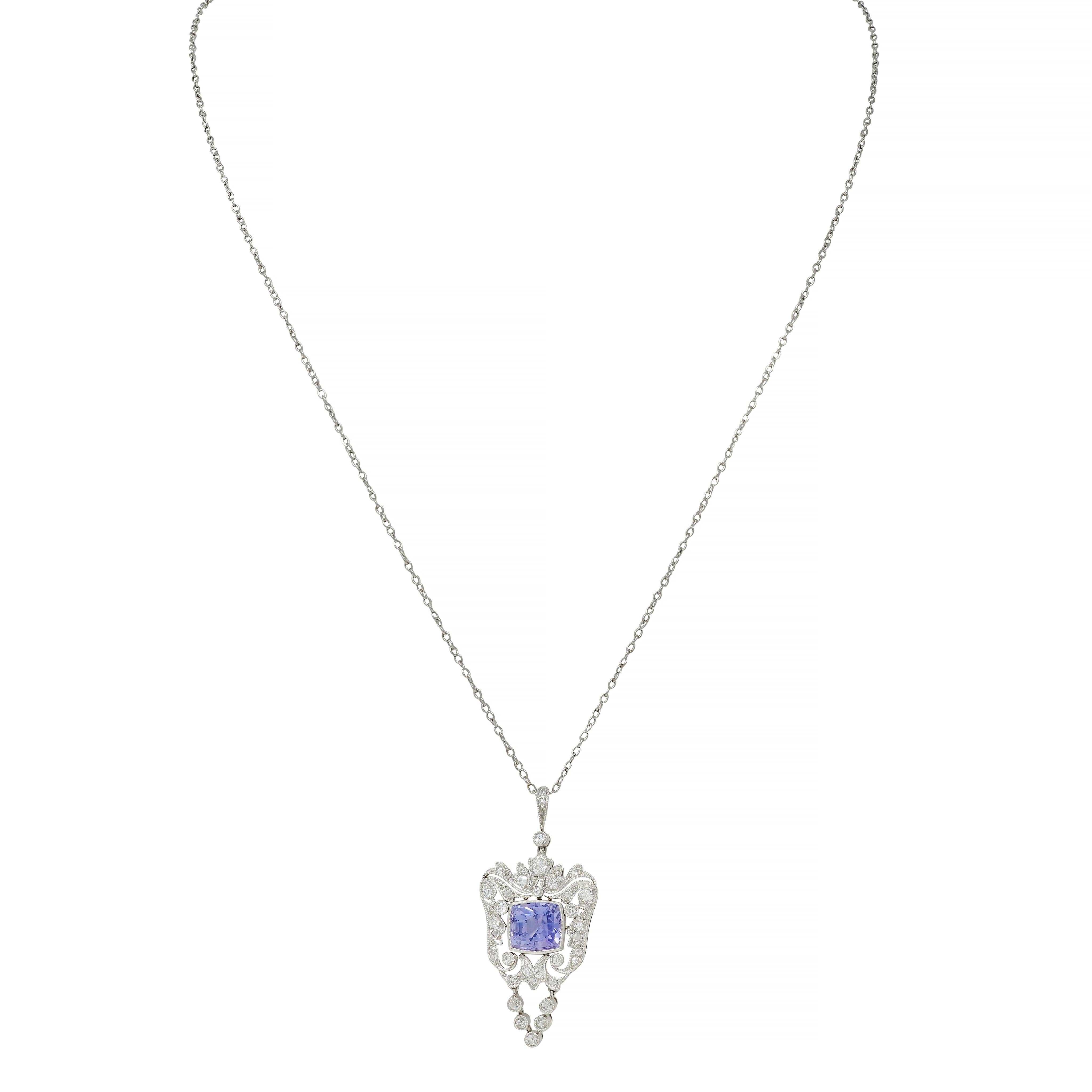 Platinum cable chain necklace suspends ornate milgrain pendant
Centering a mixed cushion cut Ceylon sapphire weighing approximately 3.04 carats
Transparent and medium light purple in color with no indications of heat - Sri Lankan in origin
Bezel set