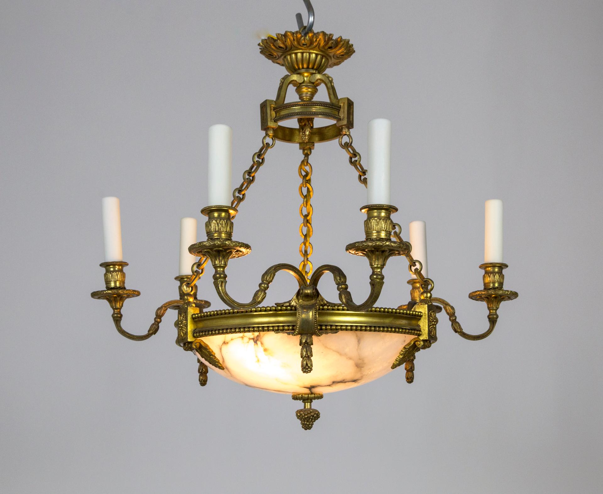A neoclassical style, Belle Époque, gilt bronze chandelier with three twin arms (6 candlestick lights) extending from a center alabaster bowl; hanging from three chains and decorative canopy. Cast with extremely fine detailing, acanthus and lotus