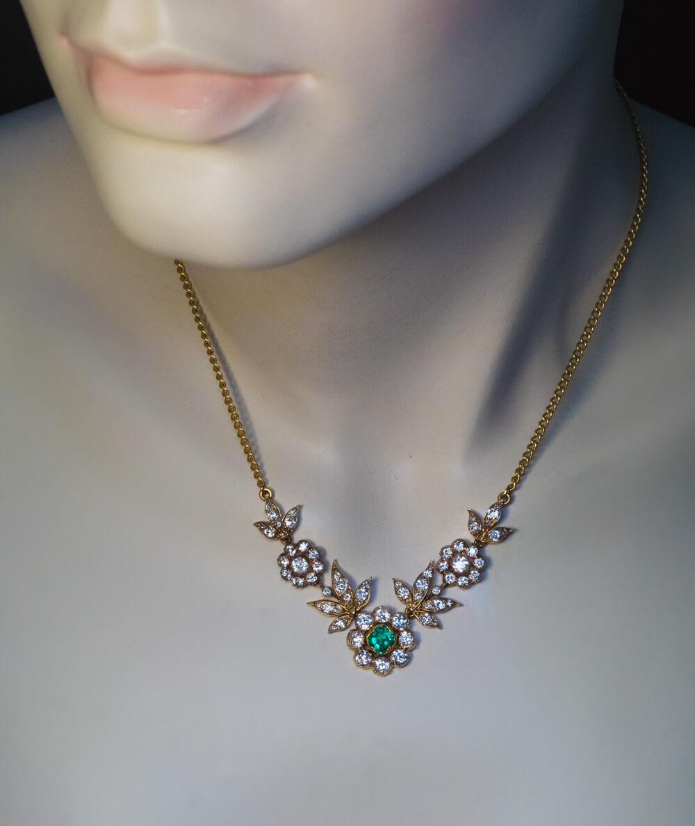 Circa 1900

This elegant antique necklace is finely handcrafted in 18K yellow gold. The necklace features an excellent Colombian emerald and bright white old European cut diamonds (F-G color, VS-SI clarity).

The emerald measures 5 x 5 x 3.7 mm and