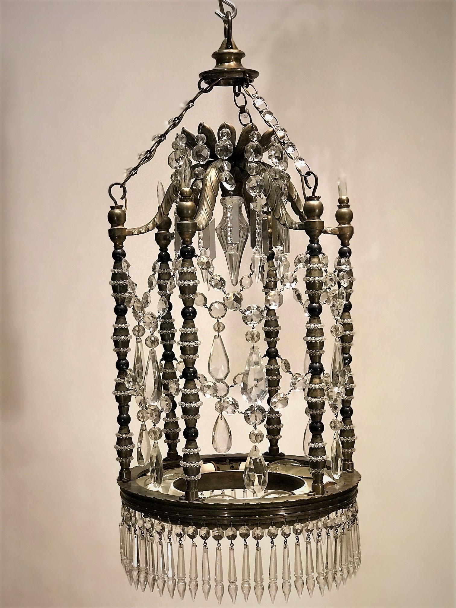 This unique lantern was probably hand made in Turkey prior to World War 1. The fixture is constructed of hand-cast brass with hand-cut lead crystal. The base has 6 indirect lights that can take up to 40 watt bulbs. The columns are stacked components