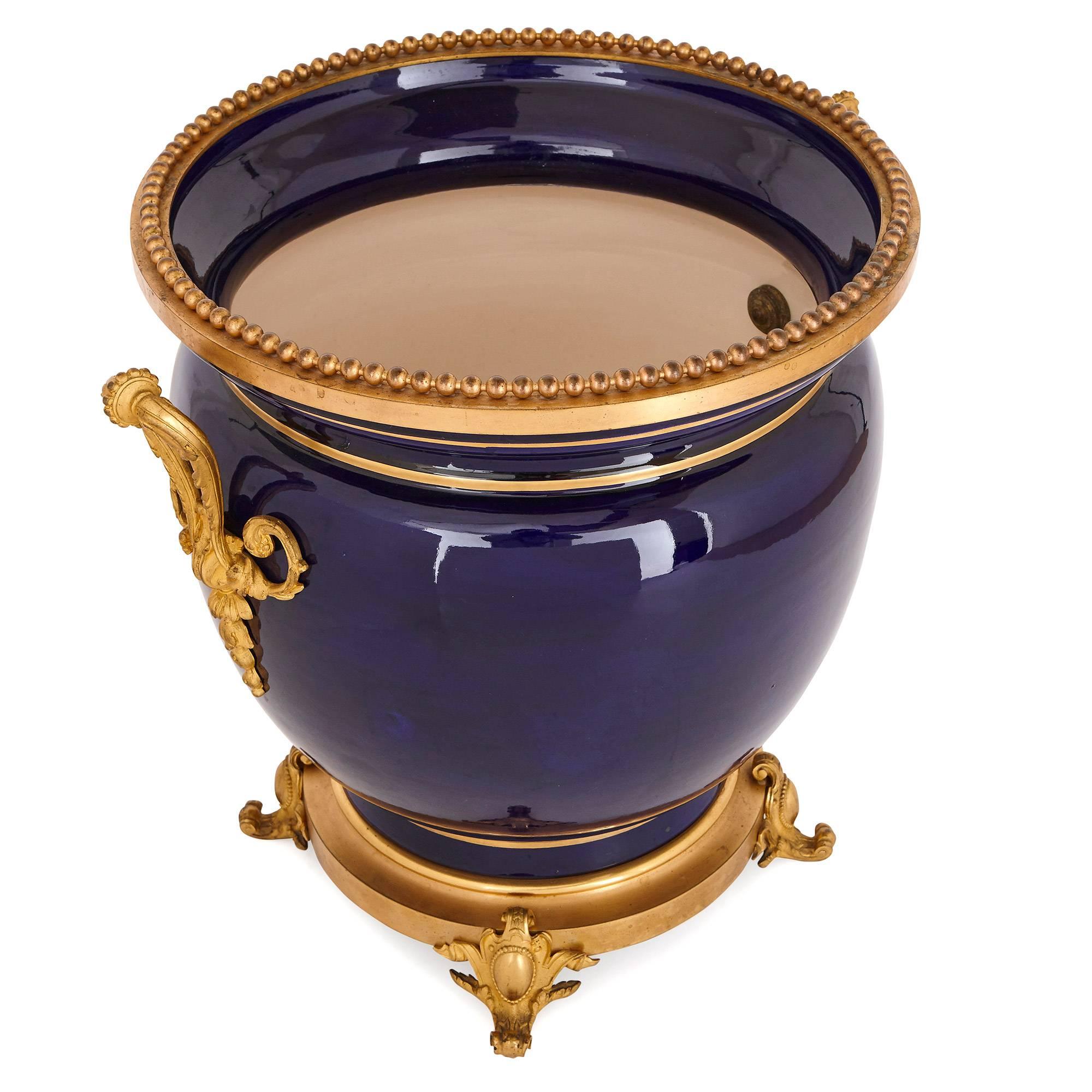 While this jardinière dates from the late 19th century, it feels strikingly contemporary in its combination of refined cobalt blue porcelain and sleek gilt bronze (ormolu) mounts.

The jardinière’s wide body is decorated with gilt bands around its