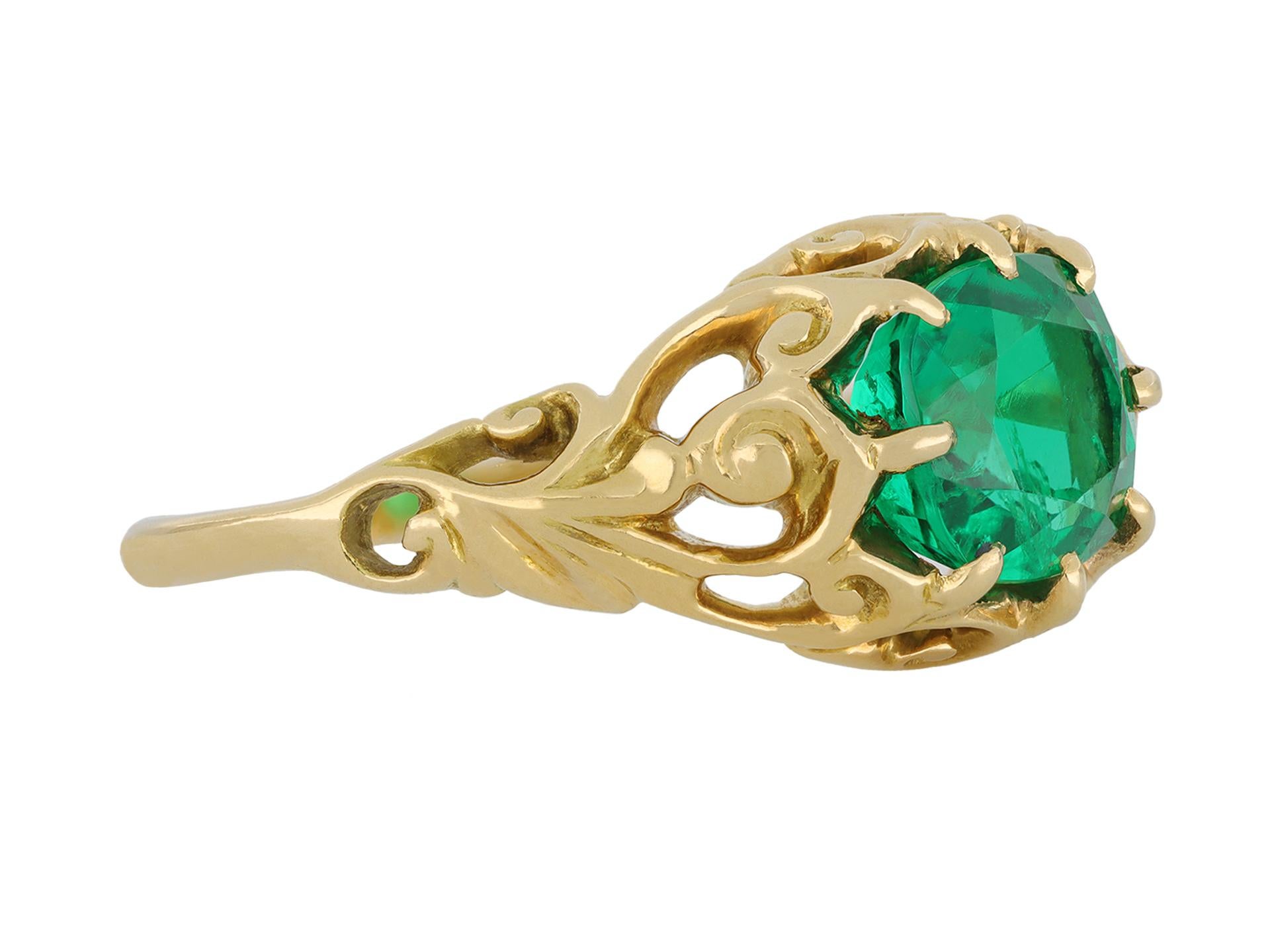 Belle Époque Colombian emerald solitaire ring. Set centrally with a cushion shape old cut natural Colombian emerald in a open back claw setting with an approximate weight of 1.46 carats, to an ornate solitaire design featuring an intricately pierced