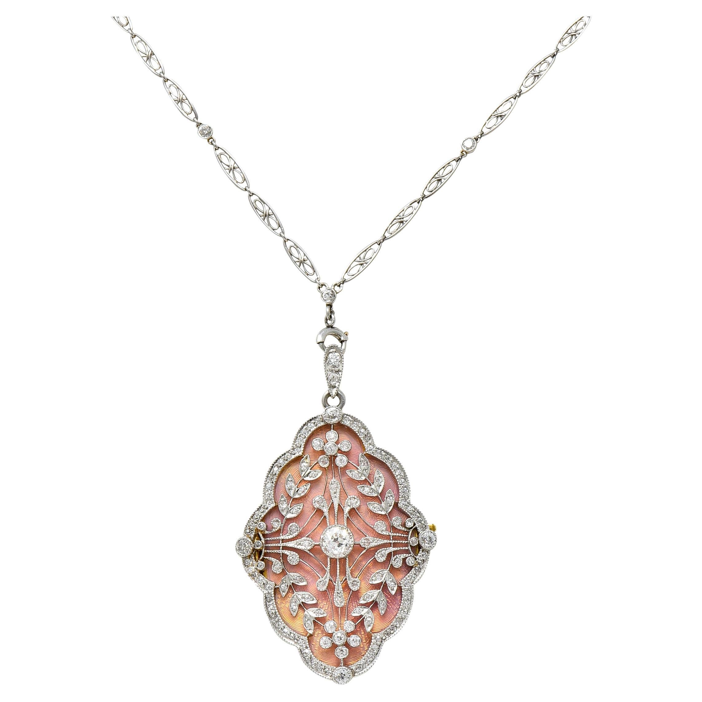 Antique diamond-by-the-yard necklace is comprised of decorative filigree links with diamond stations. Completed by a spring ring clasp and terminates as a spring ring bale. Suspending an ornate statement pendant designed as floral lattice work with