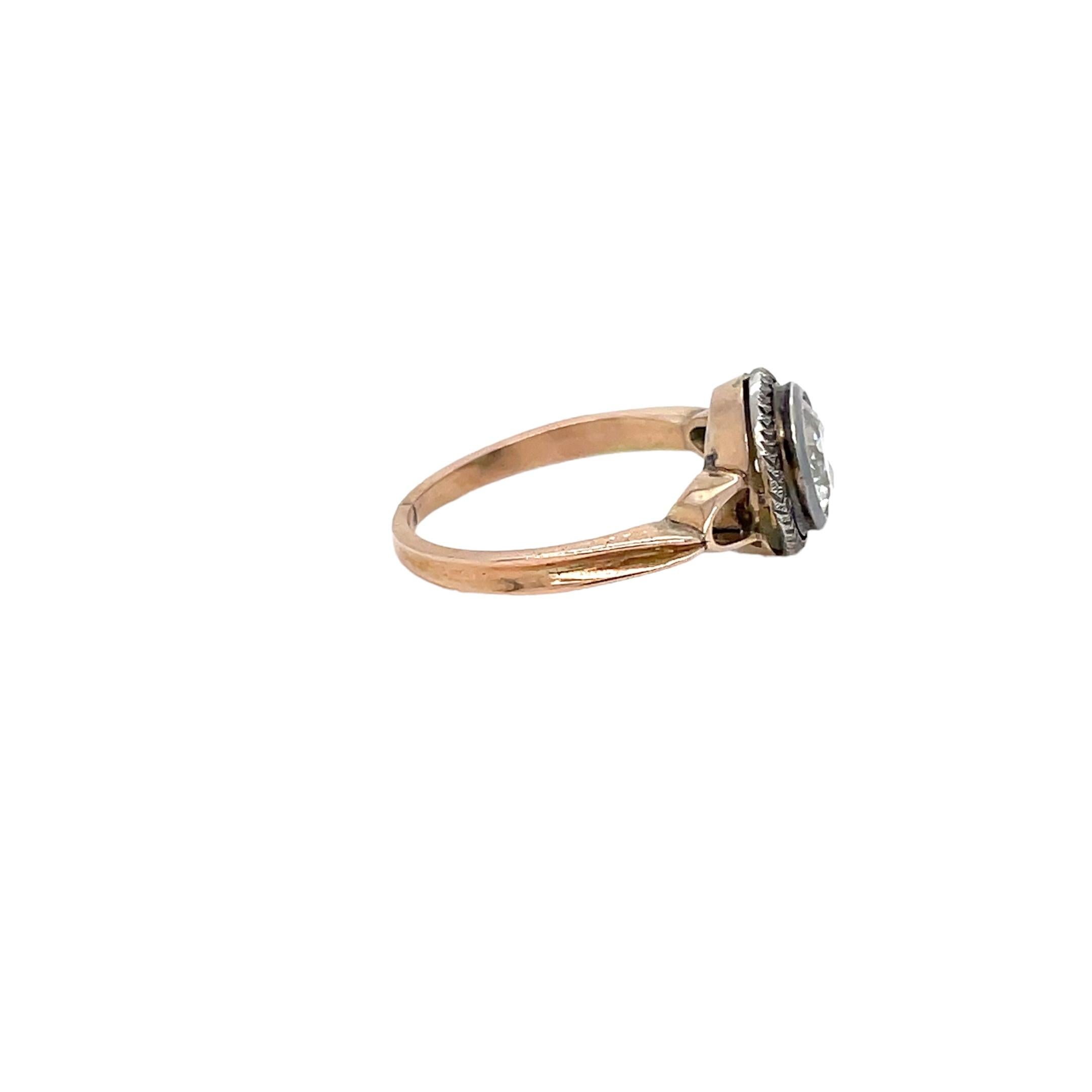 Beautiful Gold handmade genuine Belle Epoque ring.
It is set in 18k Rose Gold featuring a large sparkling Old Mine cut diamond, weight 0,90 ct. H color SI clarity. The diamond is held by a hand-engraved silver circle which makes the jewel even more