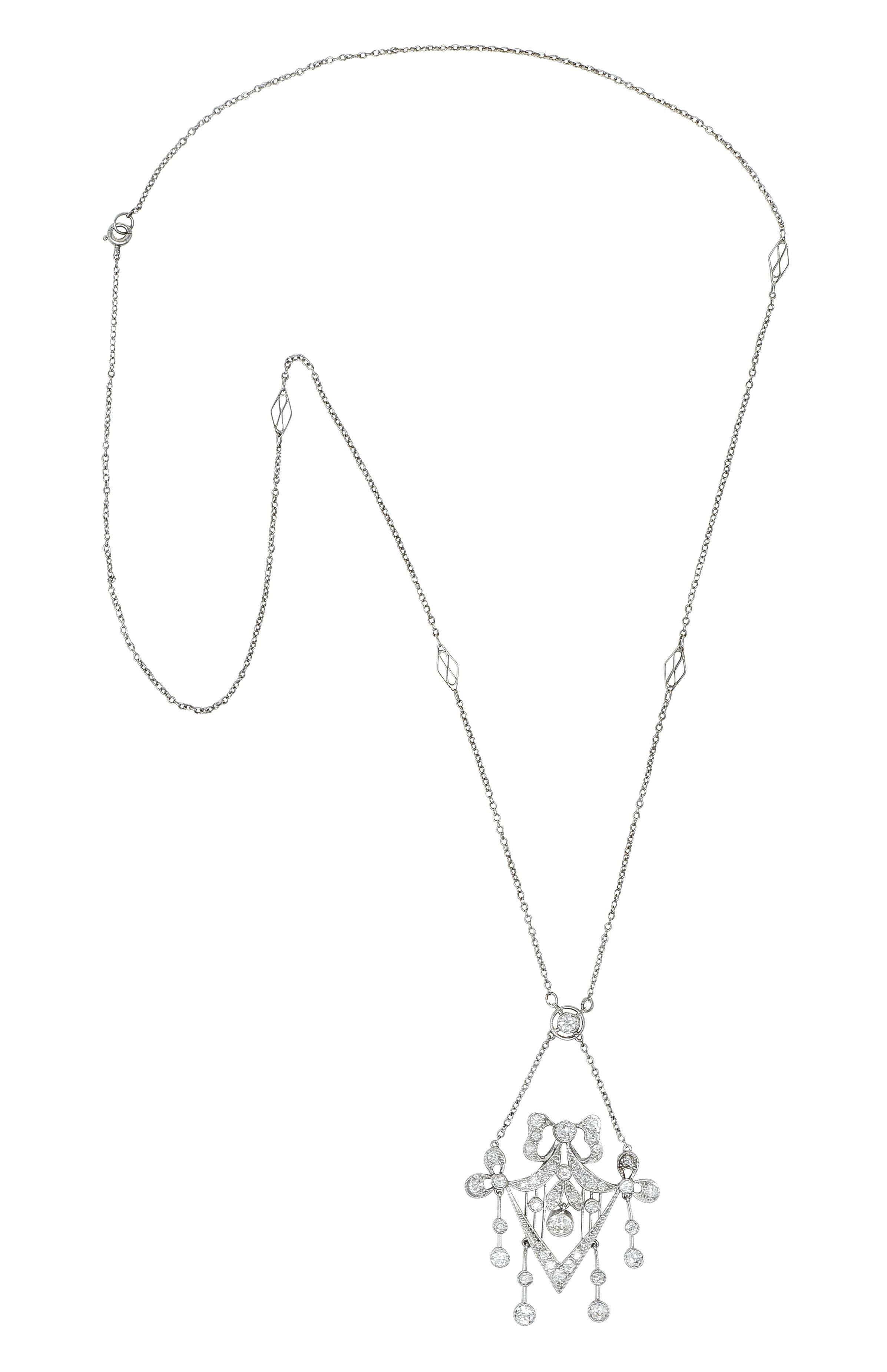 Long cable chain necklace with intermittent navette stations features a decorous center

With a circular surmount suspending swagged chain and terminating as a ribboned bow motif

Decorated with milgrain and knife edge striations - including