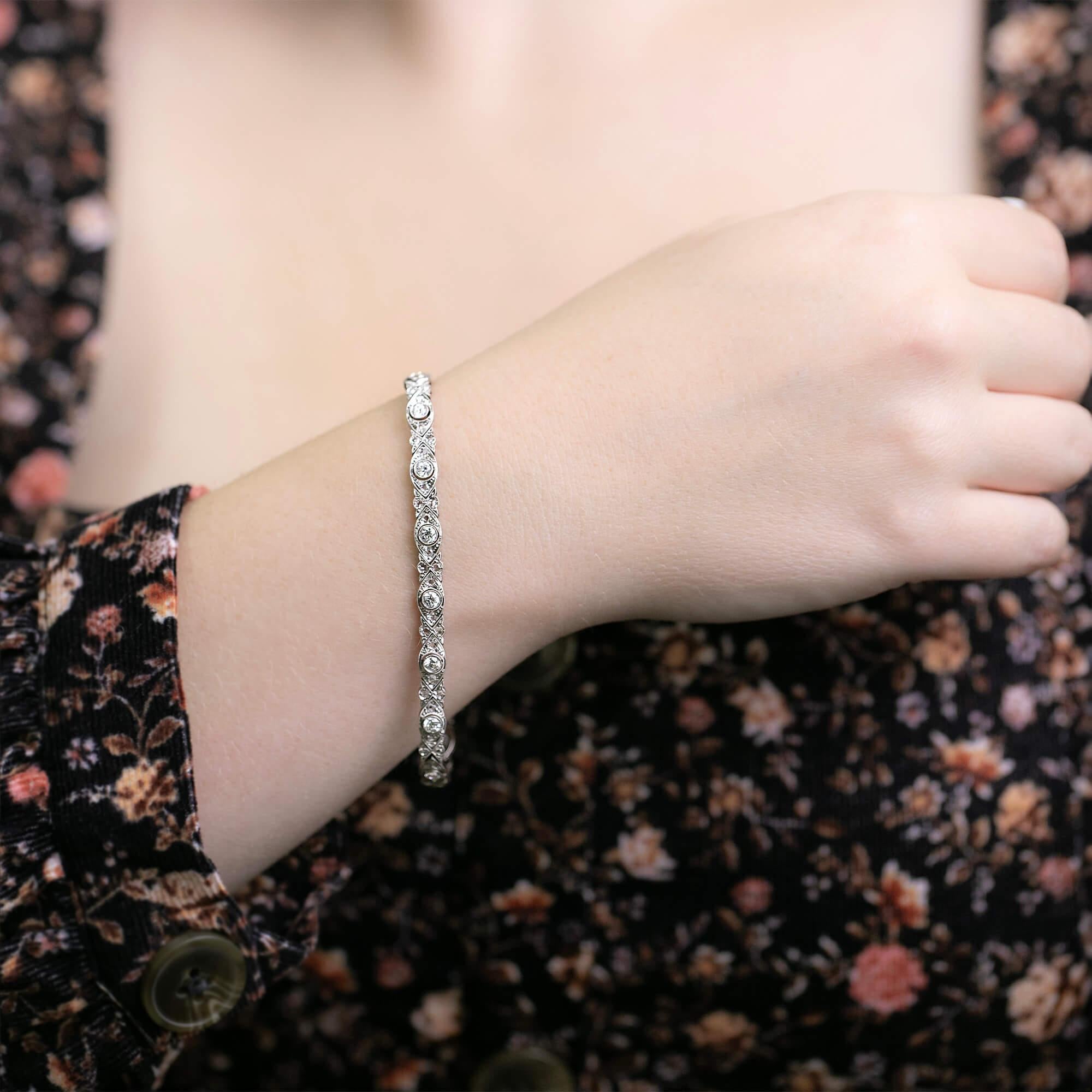 This French made bracelet from the Belle Epoque era is exquisite. An articulated line bracelet with fine bead, bezel set and mille-grained settings. Secured and fitted with a tongue snap clasp and figure eight safety catch.

Diamonds: Sixteen 3mm