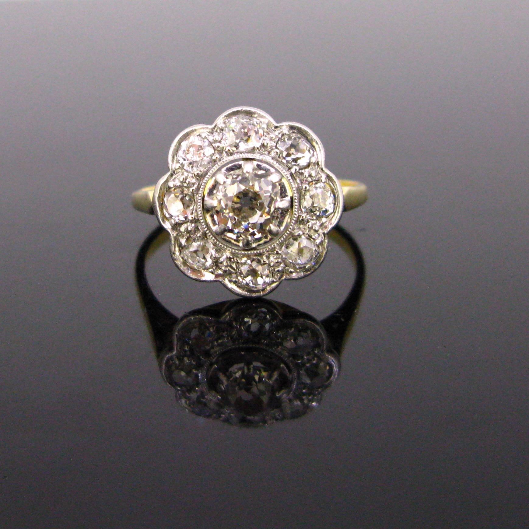 This cluster ring is made in 18kt gold and platinum. The diamonds are set on platinum and the corpse of the ring is in 18kt yellow gold. The diamonds are lively and sparkly. There is a total carat weight of 1.20ct. The diamonds have a colour range