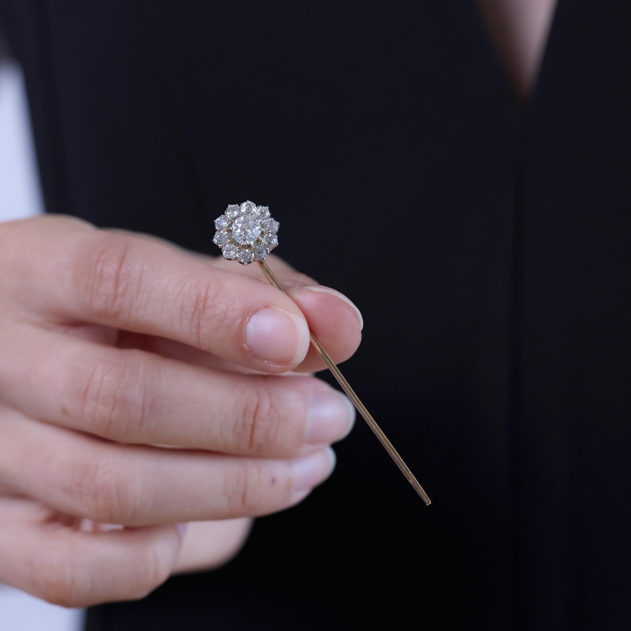 This Belle Époque pin from the 1910s is crafted in 18k rose gold and features eleven old European and old mine cut diamonds totaling approximately 2 carats. The diamonds are graded H color and SI clarity, set in a slender silhouette that reflects