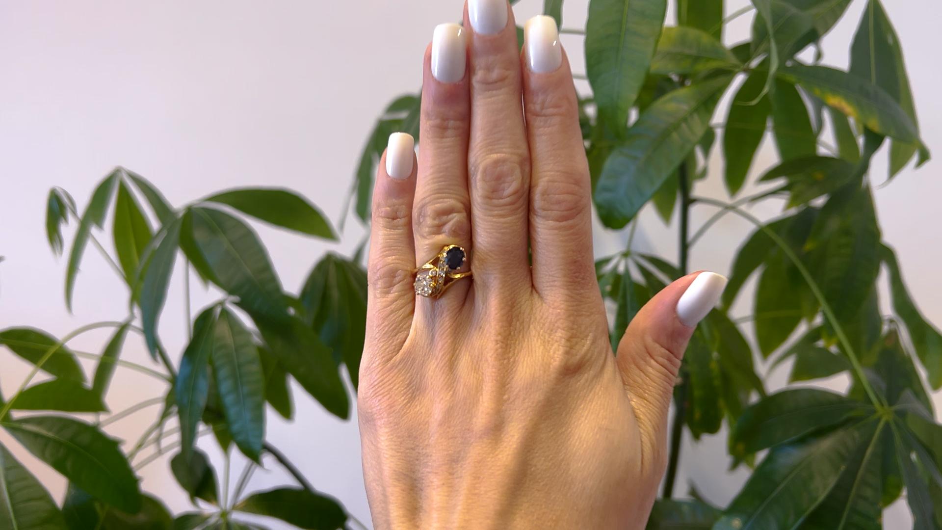One Belle Époque French Diamond and Sapphire 18k Yellow Gold Toi et Moi Ring. Featuring one old mine cut diamond weighing approximately 1.00 carat, graded I color, VS2 clarity, and one oval mixed cut sapphire weighing approximately 0.90 carat.