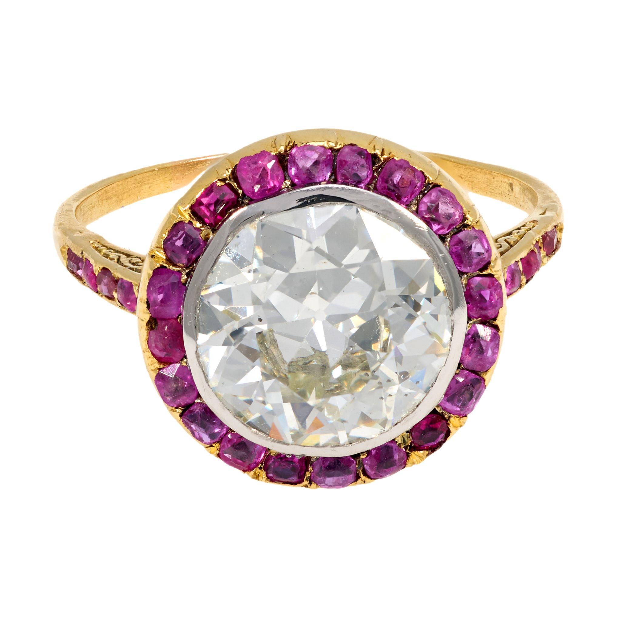 This Belle Époque French ring features a 2.92 carat old European cut diamond, GIA certified, set in radiant 18k yellow gold and platinum. Framed by 28 vivid cushion cut rubies, the design radiates early 20th-century refinement and romance. With