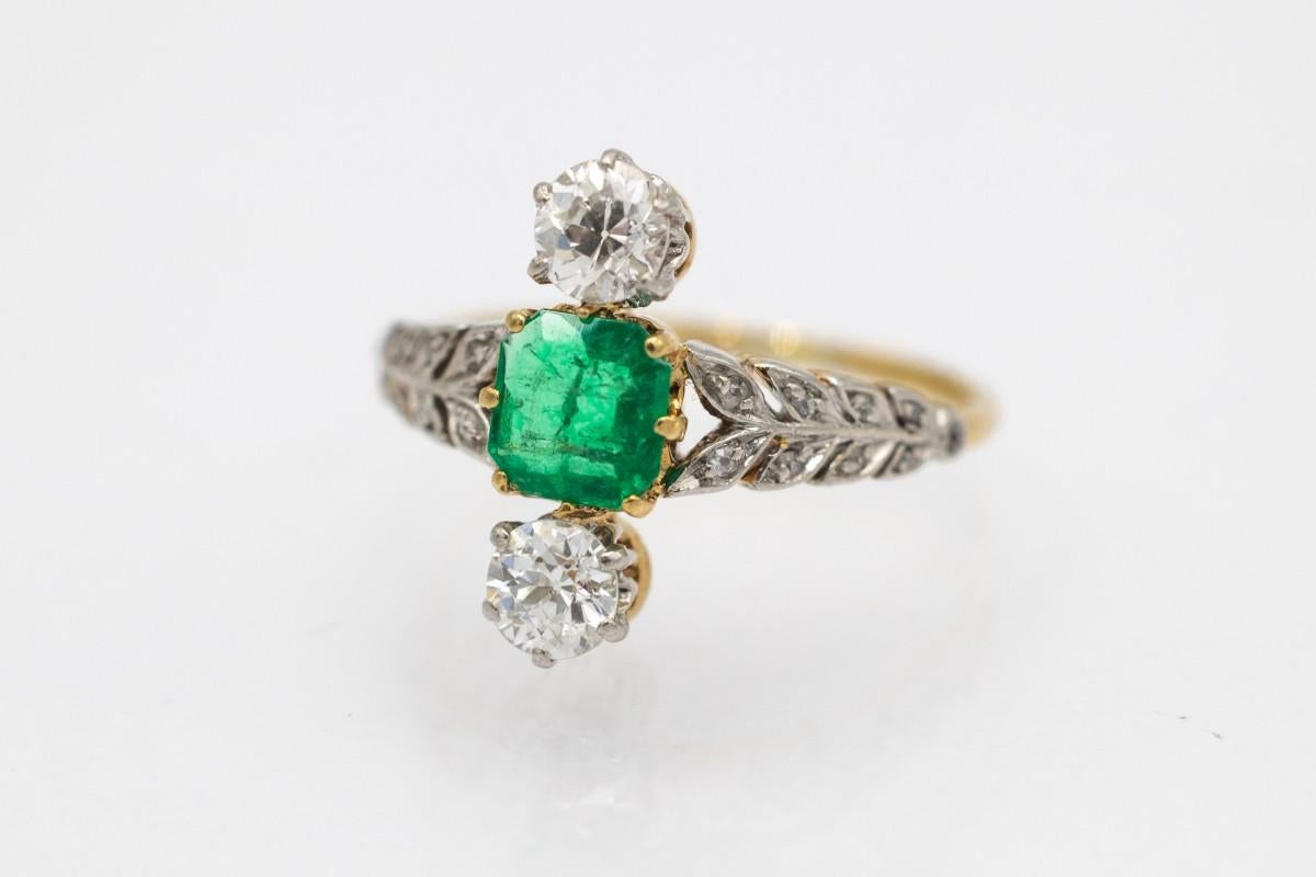 Antique ring with emerald and 2 diamonds in old European brilliant cut with a total weight of approx. 0.50 ct (color I-J, clarity SI). Additionally, the ring is decorated with other small diamonds on the sides of the ring.

Old ring made of 18-karat