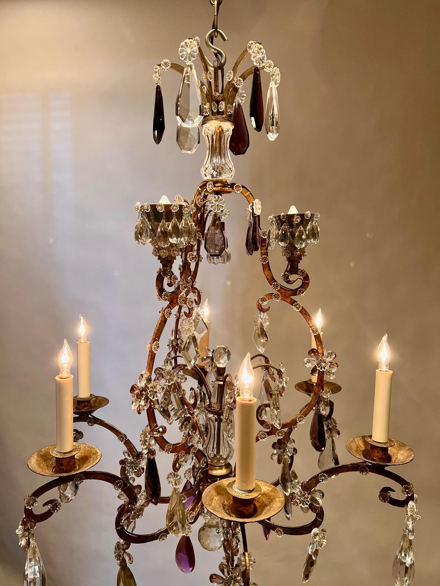This beautiful Belle Epoque chandelier started life as an all candle fixture in the 1870's in Paris. Around 1895 3 electrified crystal encrusted cups were added at the top during the craze by the rich for electric light in France. Years later the