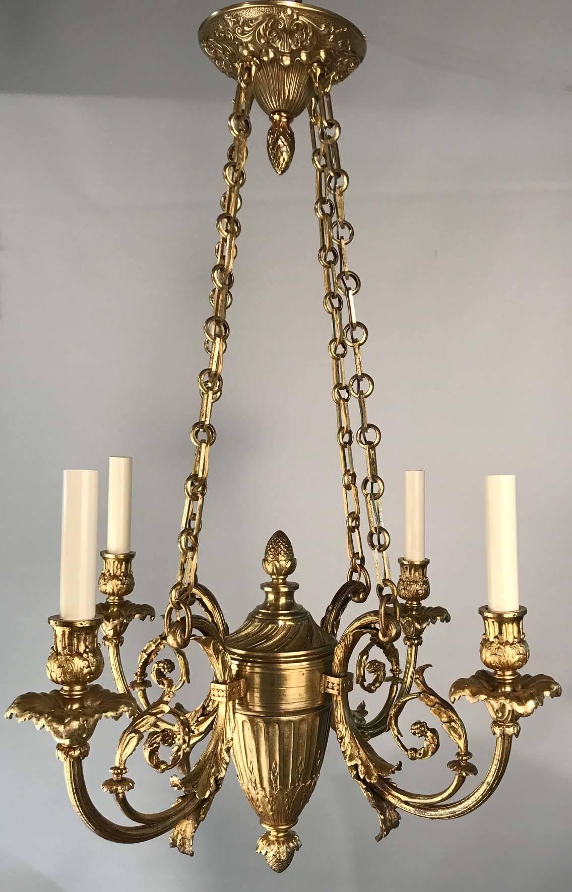 This small but exquisite fixture is of unusually high quality. Diminutive lighting of this type is difficult to find. It has four scrolling arms ,cast with acanthus, emitting from a central turned hub. From the pineapple finial, emblematic of