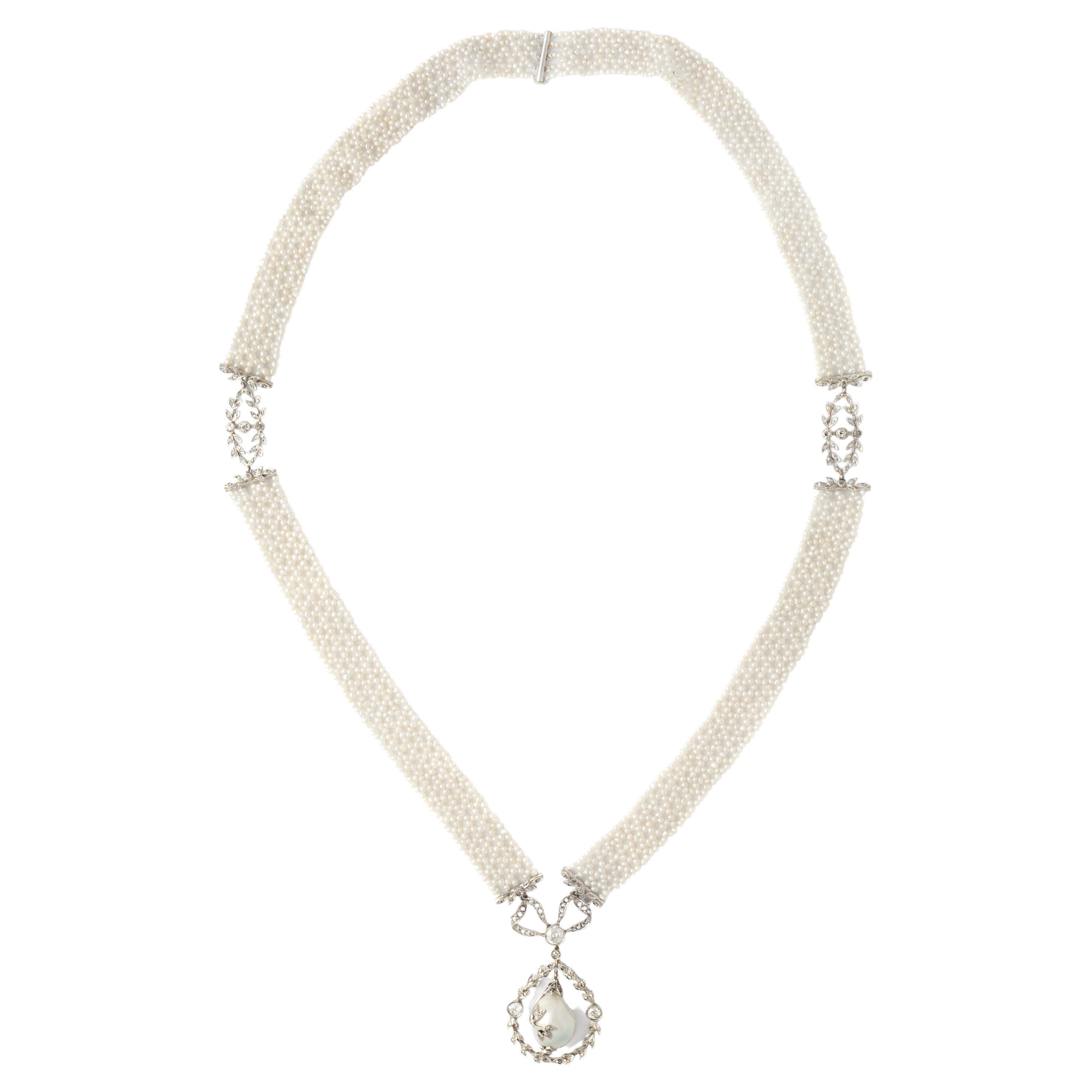 Belle Epoque necklace natural pearl, diamond and platinum. Pendent is holding a baroque natural pearl 13.87 carats not treated. Certified Swiss Laboratory.

This Belle Epoque necklace showcases a natural baroque pearl, weighing 13.87 carats,