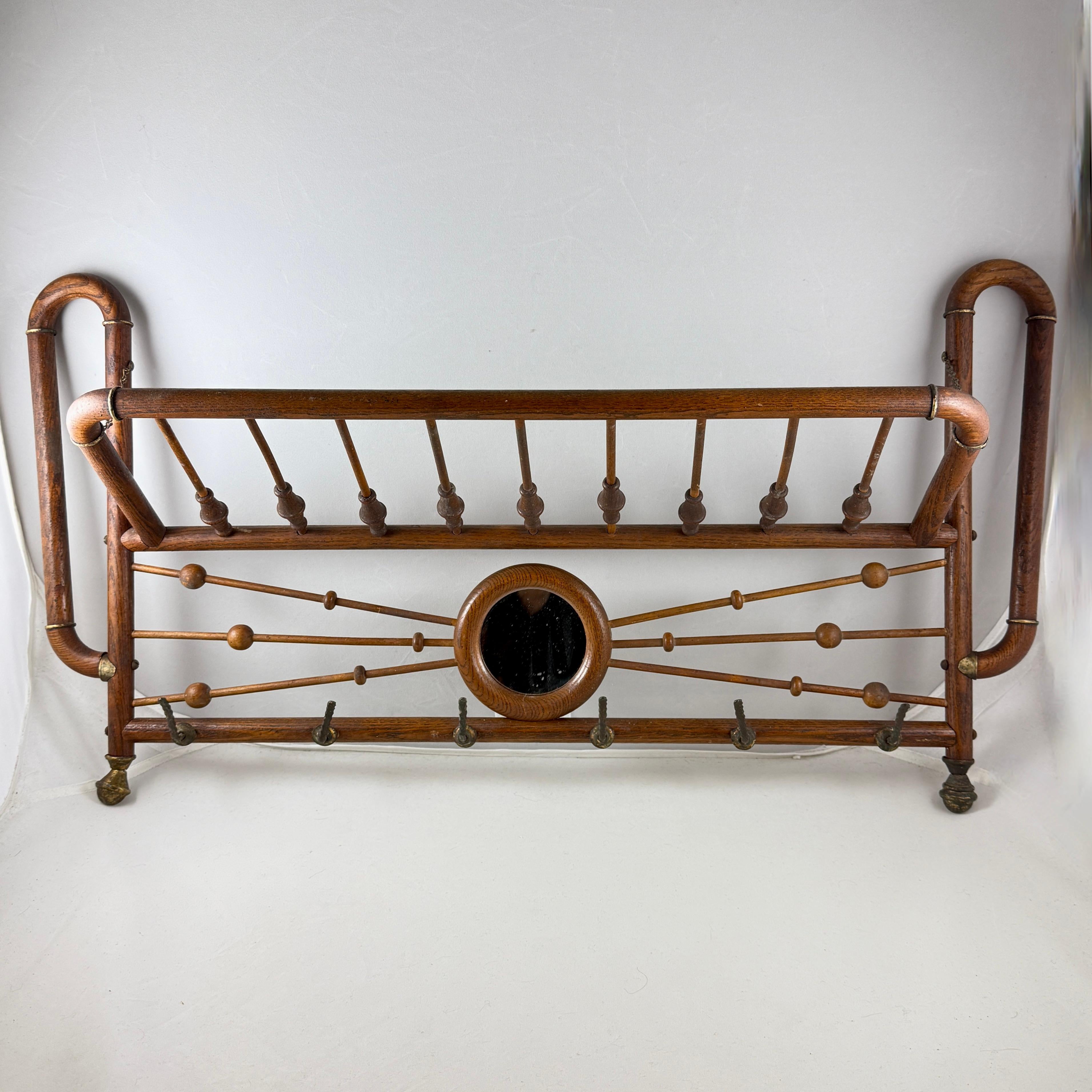 From the Belle Epoque Era, a hanging and folding Bentwood Oak and Brass coat and hat rack, France, circa 1880-1900.

A highly decorative hanging wall rack, beautifully hand made, suitable in the front hall for holding jackets, scarves and hats. Also