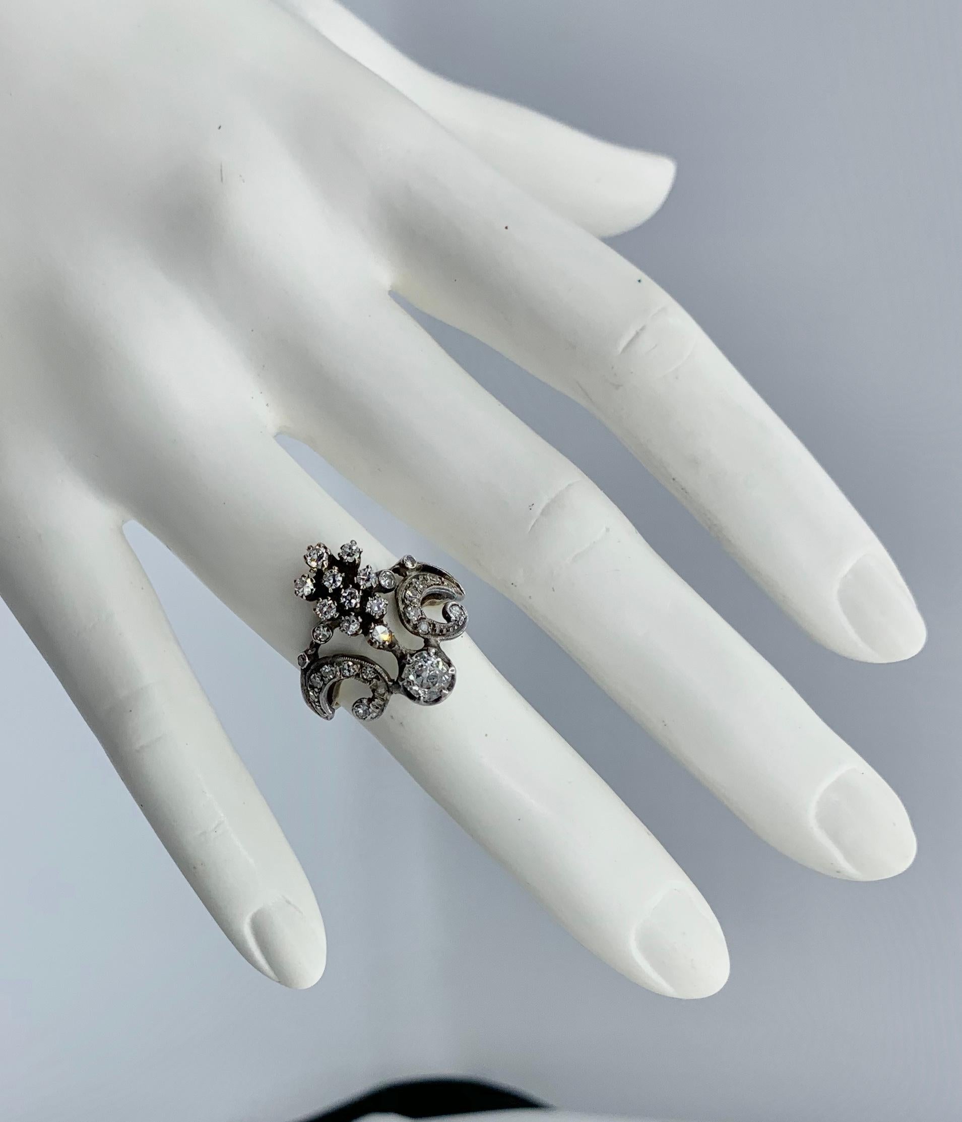 This is an extraordinary antique Belle Epoque Old Mine Cut Diamond Ring in a stunning and very rare Crown or Tiara motif of great beauty.   The Old Mine Cut Diamonds are set in Silver atop 18 Karat Gold as was the custom of the period in order to