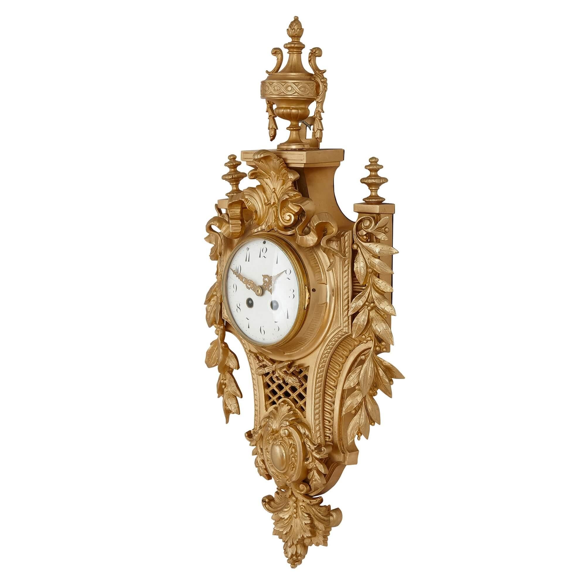 Antique French Louis XVI style gilt bronze cartel clock
French, late 19th Century
Height 63cm, width 28cm, depth 10cm

This elegant cartel clock is crafted from gilt bronze in the Neoclassical style. The clock features a central white enamel dial,