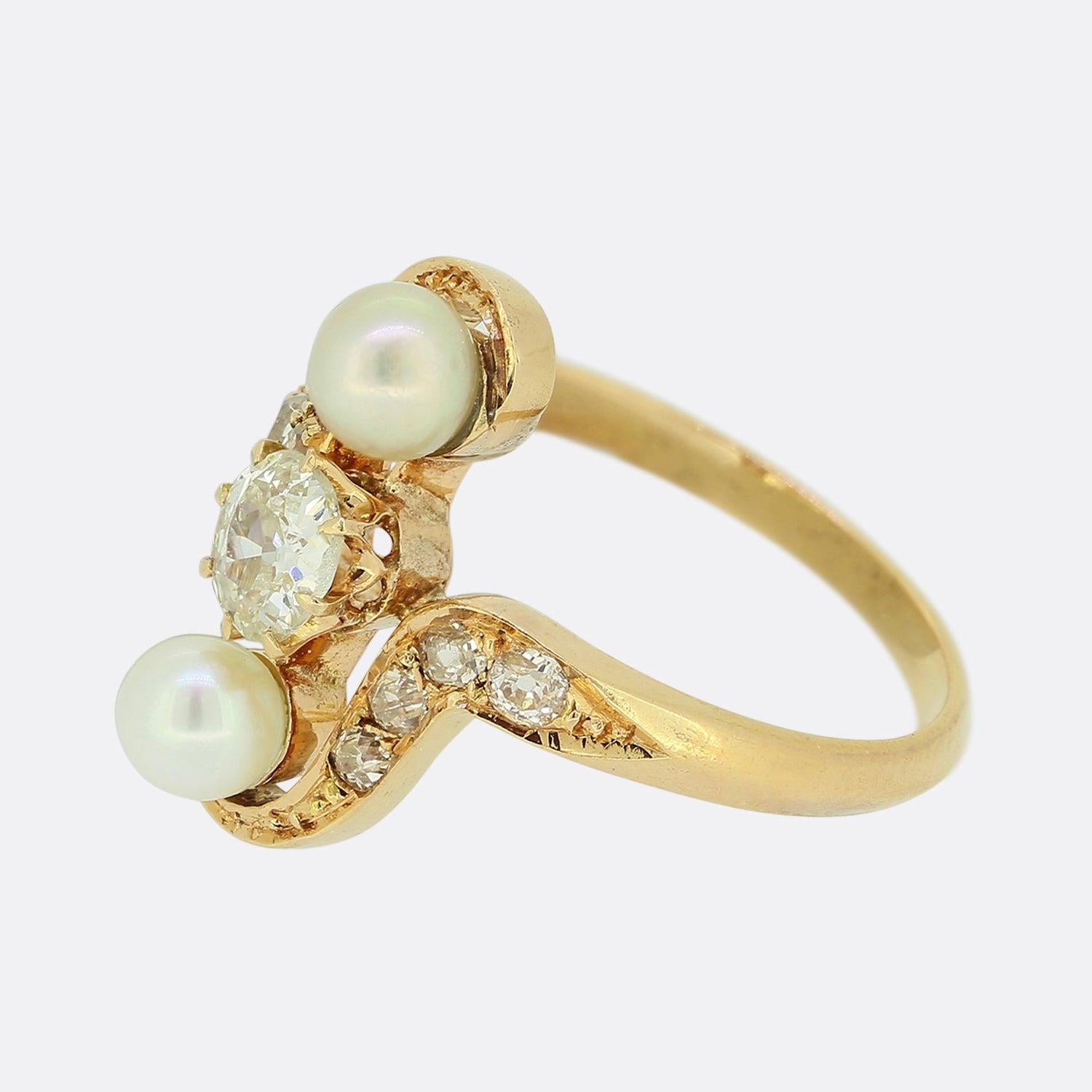 Here we have a charming pearl and diamond ring dating back to the Belle Époque era. A single round faceted old cut diamond has been claw set at the centre of the face amidst a round shaped pearl above and below. The trio sits proud atop a swirling
