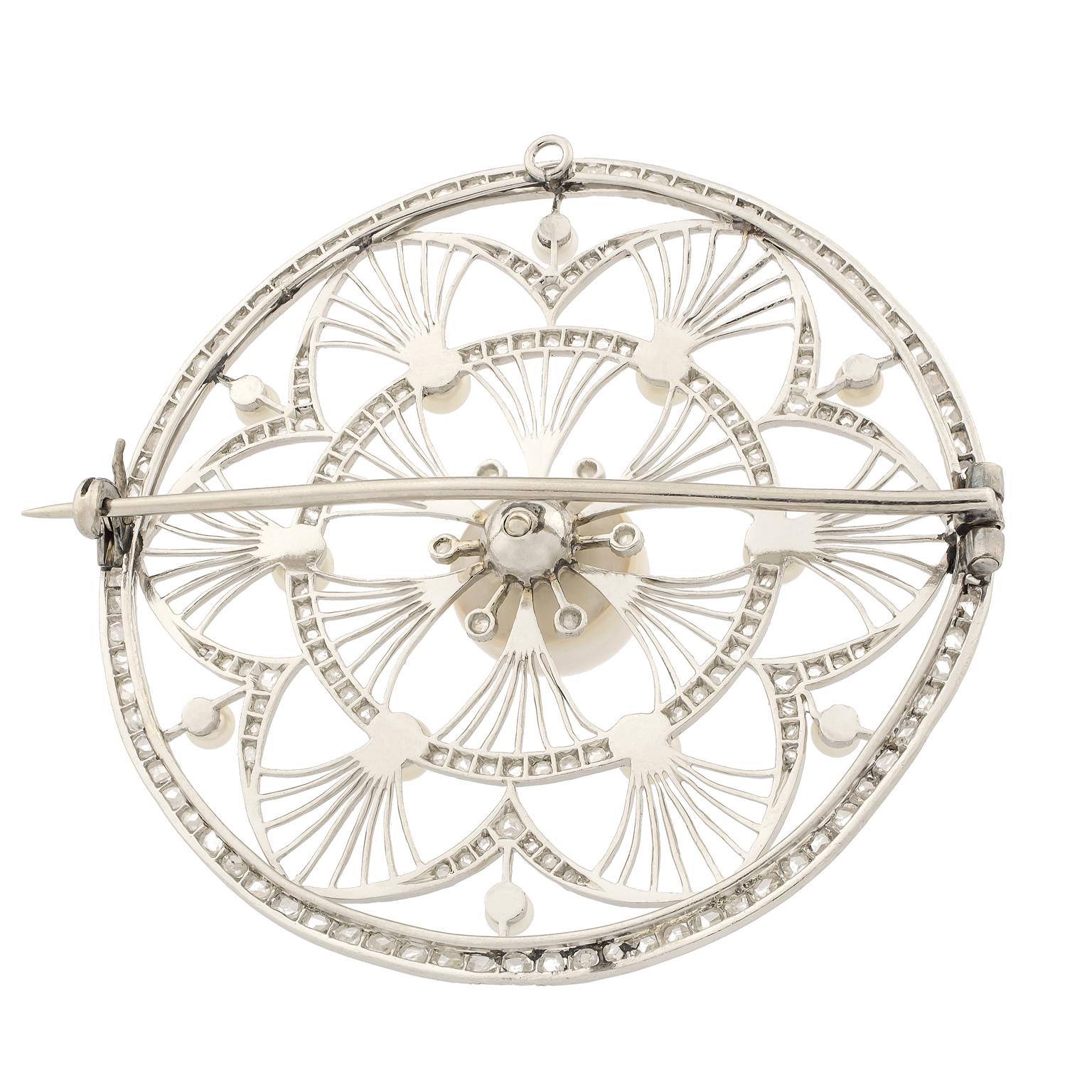 Circular Belle Époque platinum brooch with a central natural pearl encompassed by pearls and rose cut diamonds