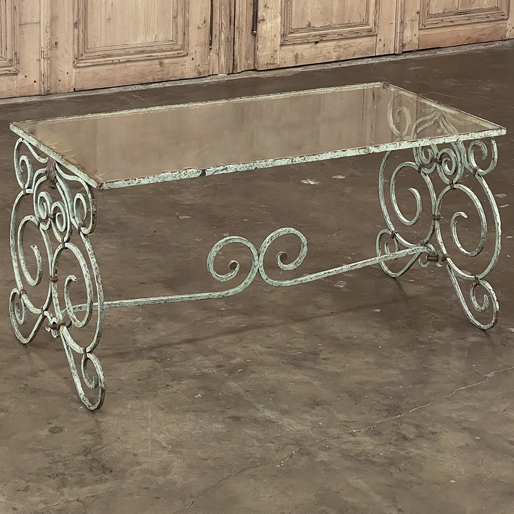 Belle Epoque Period French Painted Wrought Iron & Glass Coffee Table features a Classic style unlike the modernist movement's straight and uninspired lines. The intricate scrolls within scrolls design required the skills of a talented metalsmith,