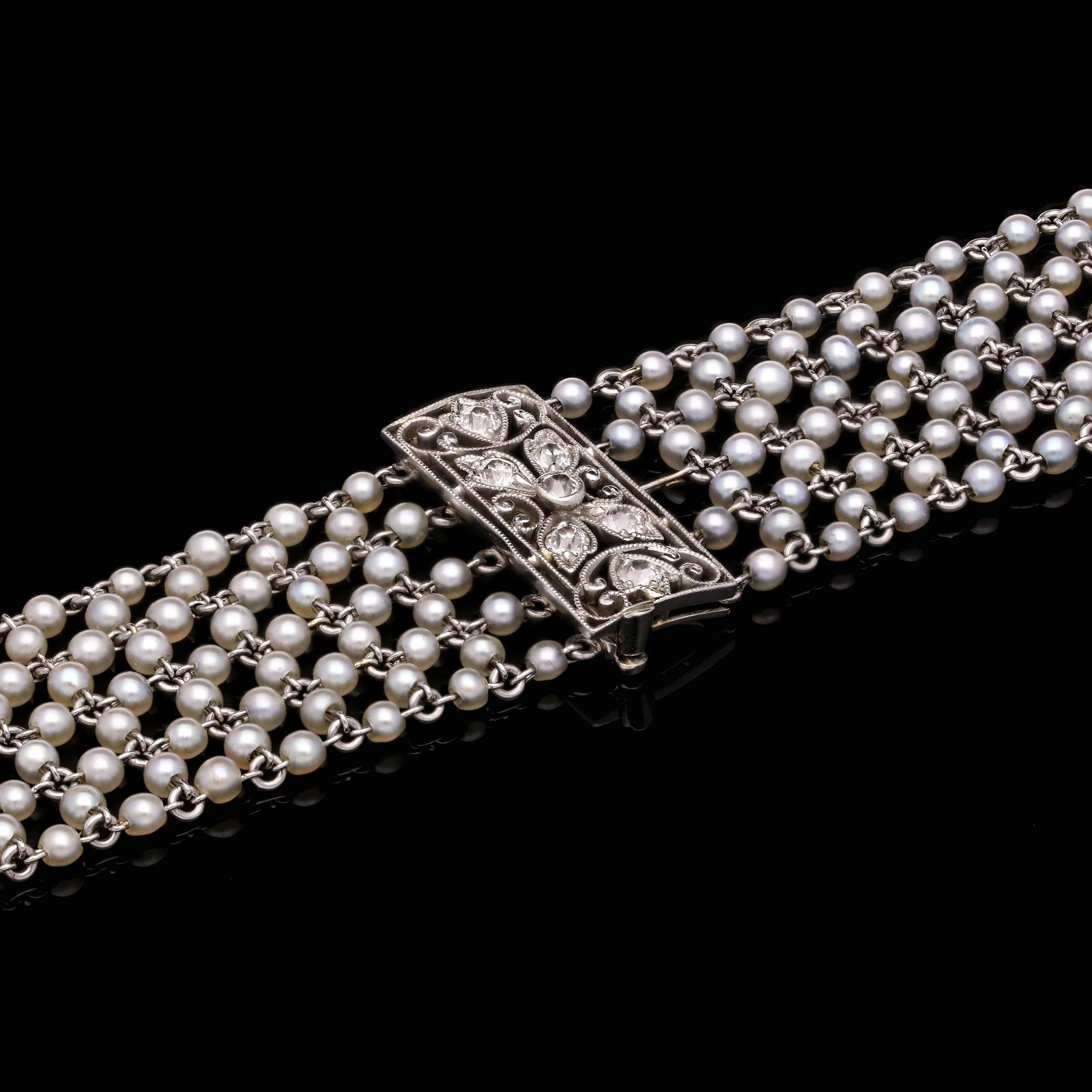 A beautiful Belle Epoque platinum, natural seed pearl and diamond choker necklace by Theodore B. Starr c.1910, designed as a delicate woven mesh of round cream seed pearls threaded onto platinum wire threads and linked together to form a highly