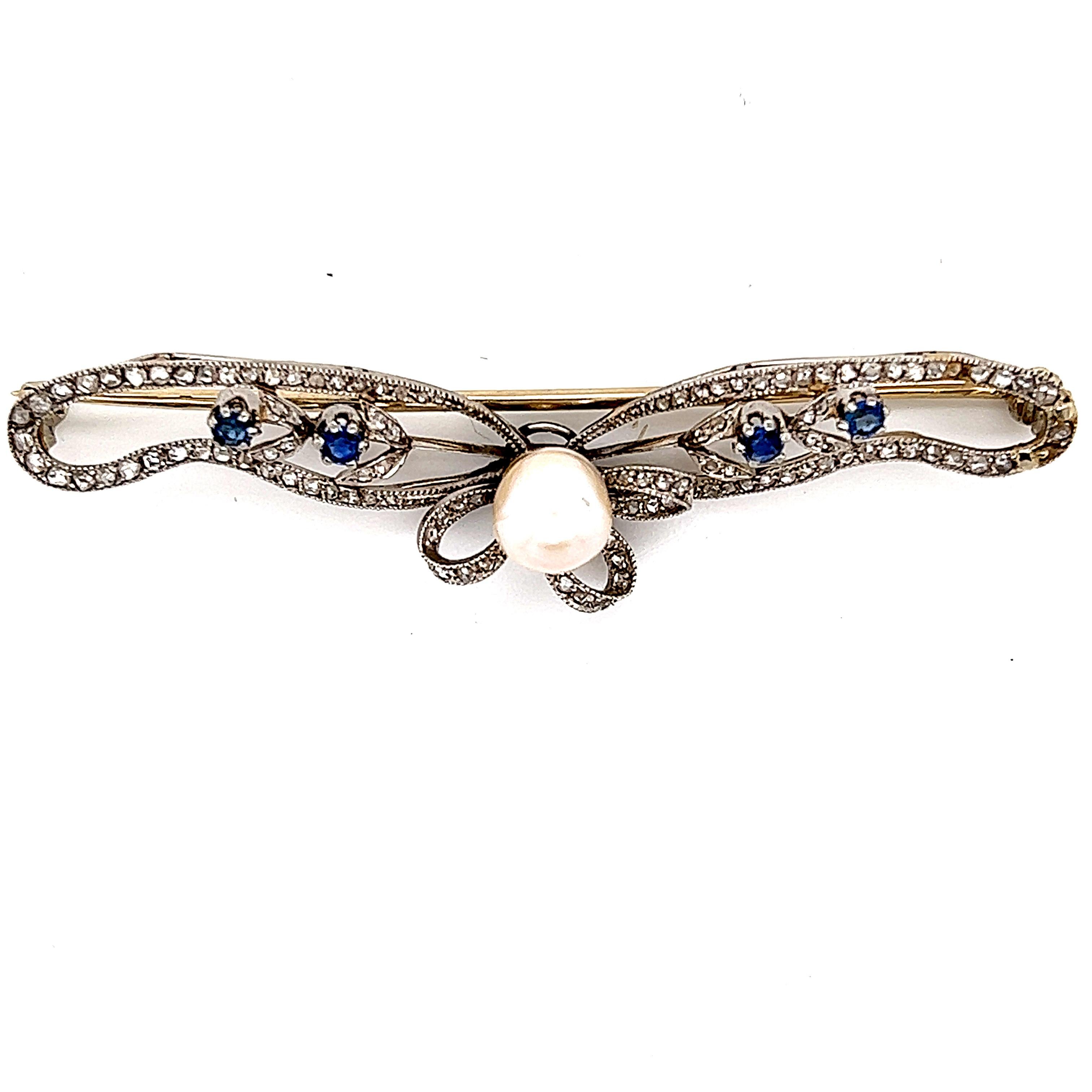 Fantastic display of Belle Epoque jewelry with this decadent ribbon brooch crafted in platinum and 18k gold. The Brooch displays a swirling pattern with a focal point of a center set pearl gemstone with exceptional luster. The brooch is set with
