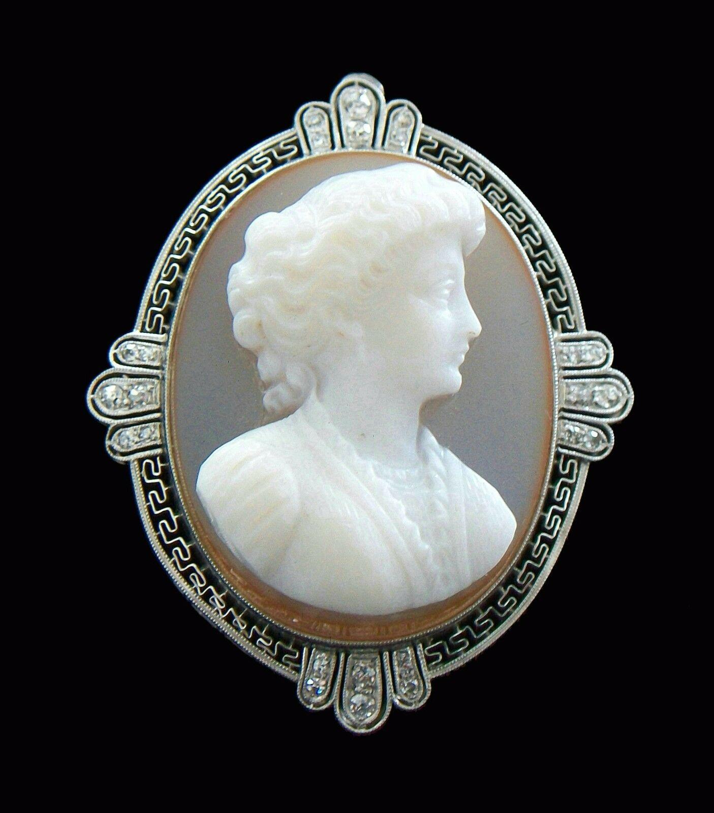 Extraordinary Belle Époque custom made hand carved sardonyx cameo brooch or pendant with retractable bail - the deep relief three layer sardonyx cameo (brown  mauve  white) contained in a filigree and mill-grained Platinum frame with a Greek key