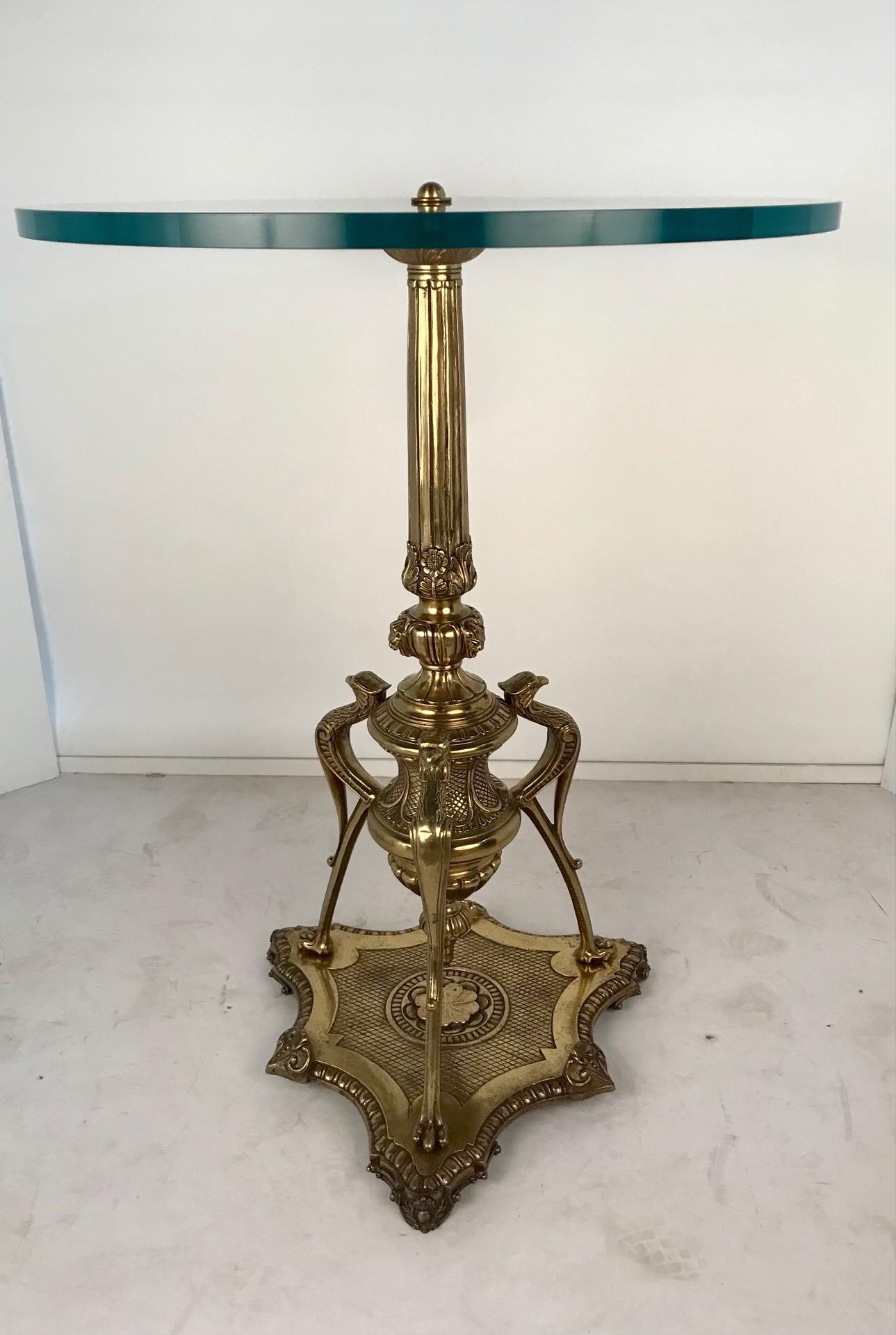 This unusual table stands on a heavy shaped tripod base .The  turned baluster stem is vase-shaped and supported by three long-legged birds. The base and stem are extensively modelled with leaves and lobed motifs and then highly polished.