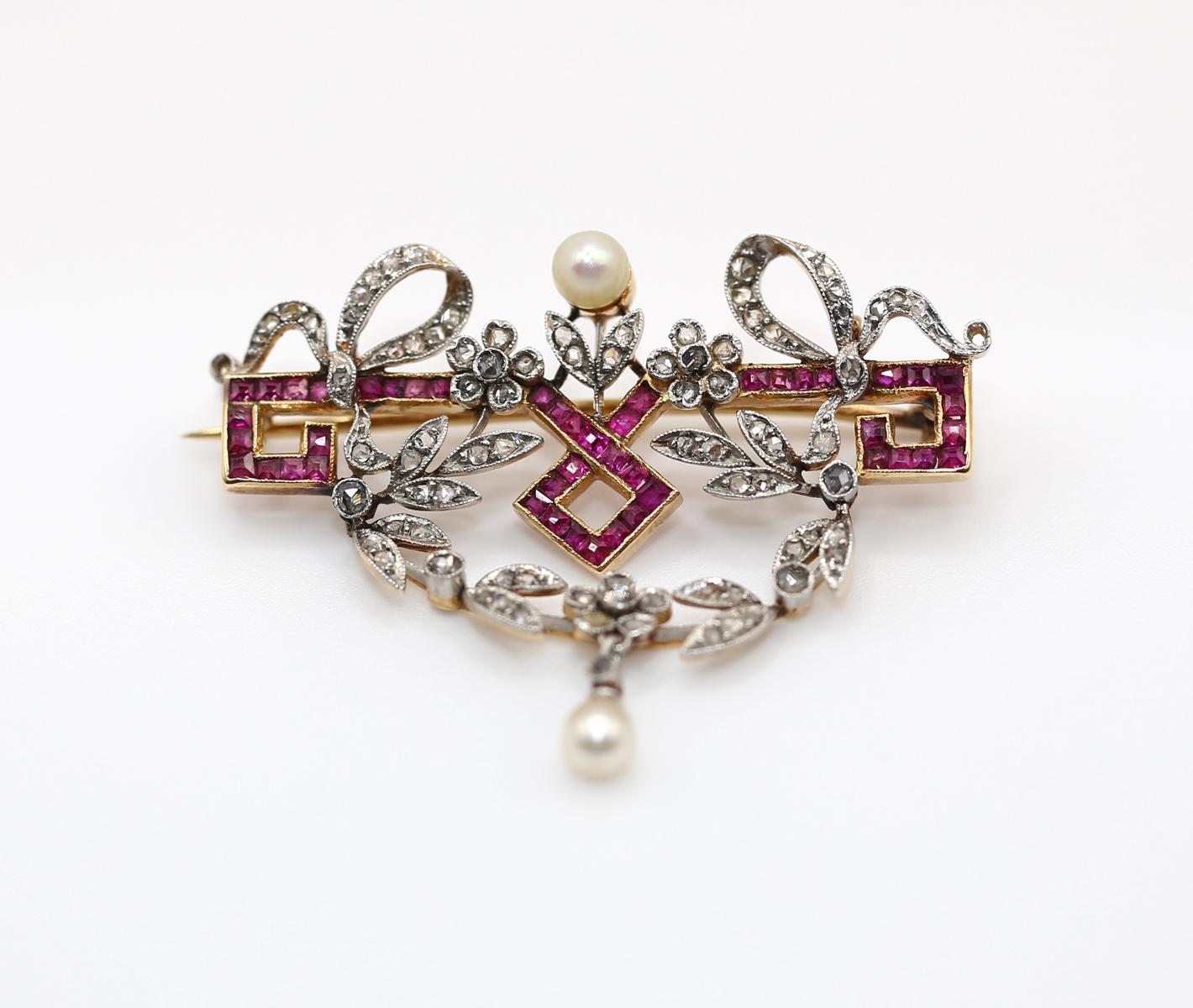 Belle Époque Brooch with Rubies, Pearls, and tiny Rose-cut Diamonds. Elegant and artistically crafted items of fine jewelry. Created around 1900 in France. 
A row of Rubies set to a geometrical line and squares form. 
Rose-cut Diamonds are set