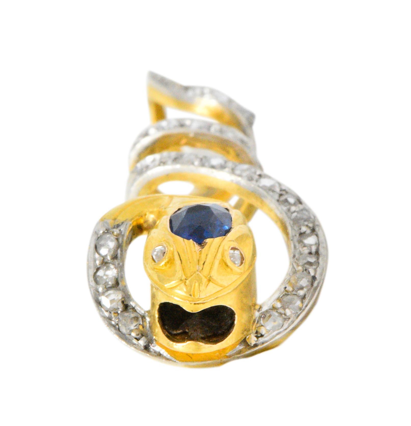 Designed as a coiled snake with an oval cut sapphire inset on the head of the snake, the sapphire weighing approximately 0.30 carats, bright blue

Accented with rose cut diamond eyes and along the body, weighing approximately 0.15 carats, eye-clean
