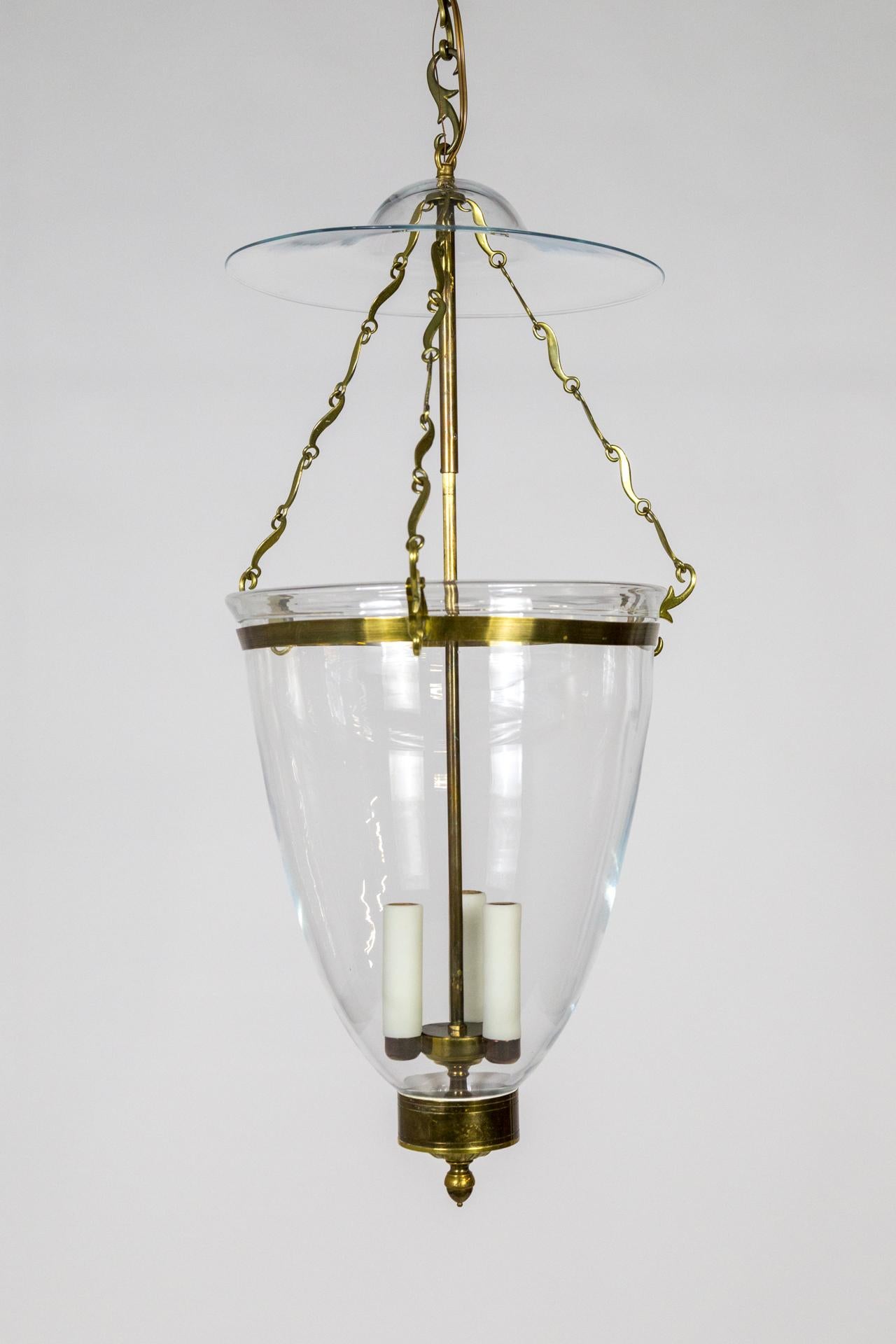 Belle Époque style, oversized glass and brass bell jar lantern, pendant. Acanthus leaf and acorn detailing with custom delicately swirled chain links. American made by Ball and Ball Co of Pennsylvania. Newly wired, 3 e12 sockets. UL listing