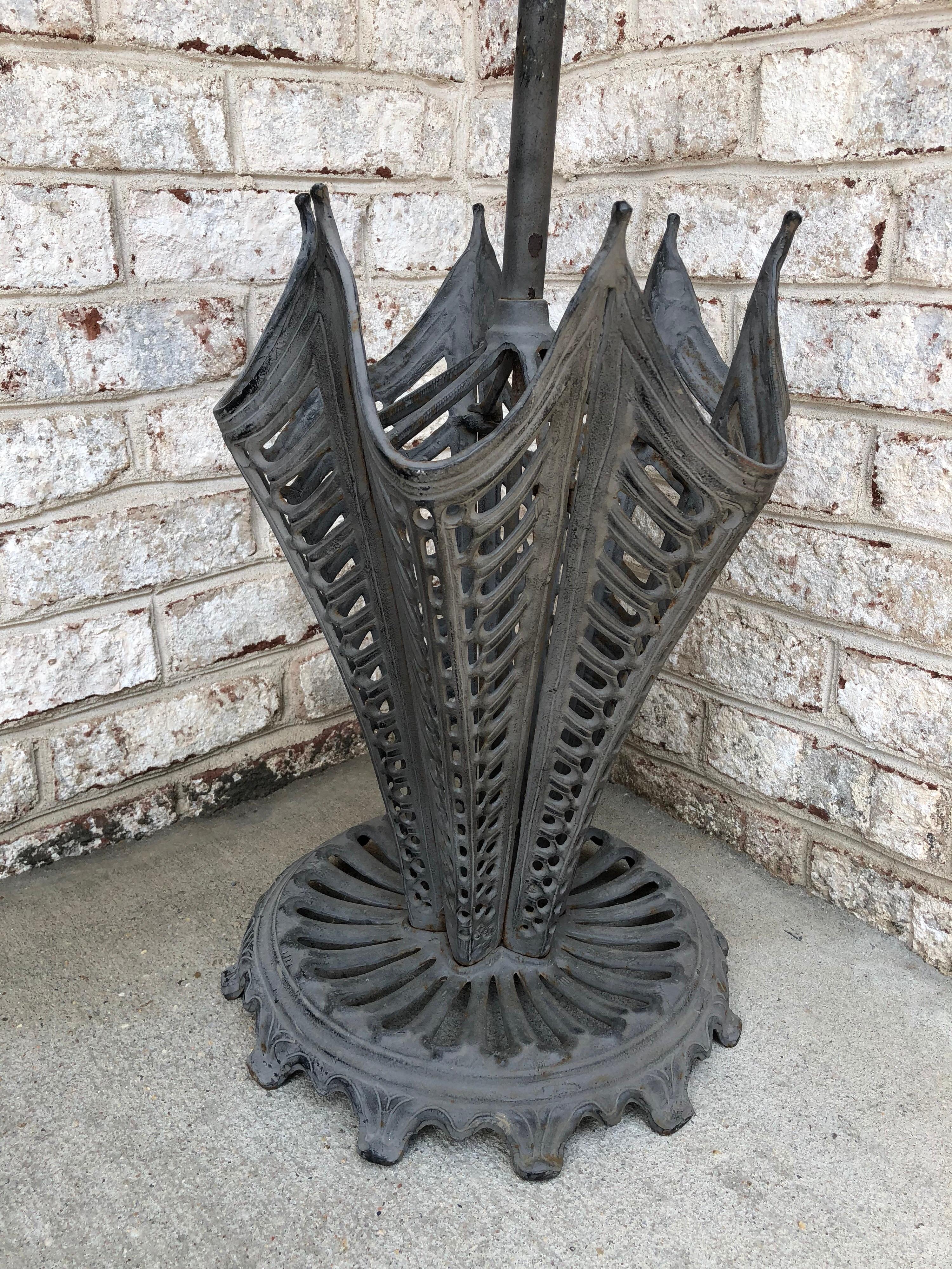 Made in England of cast iron ‘circa 1900s’, this very heavy umbrella stand is in original condition. Rare and whimsical with clutched hand to top, over the top cut out umbrella shape.