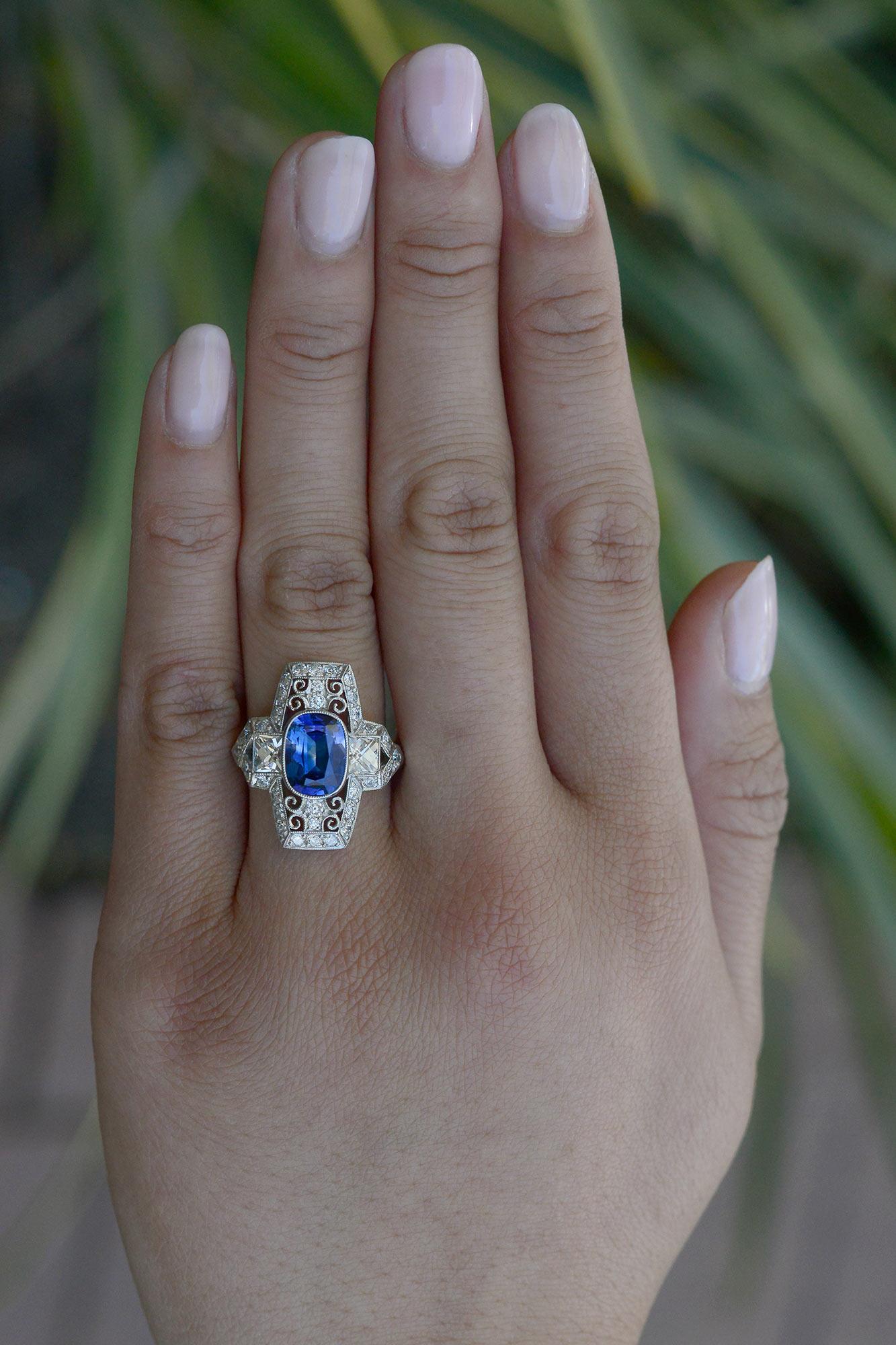 Crafted in reminiscence of the great Belle Epoque era, this elongated filigree engagement ring makes a major statement. The 2.13 carat cushion cut Ceylon sapphire exhibits a lustrous, vivid blue and is well balanced with the surrounding platinum