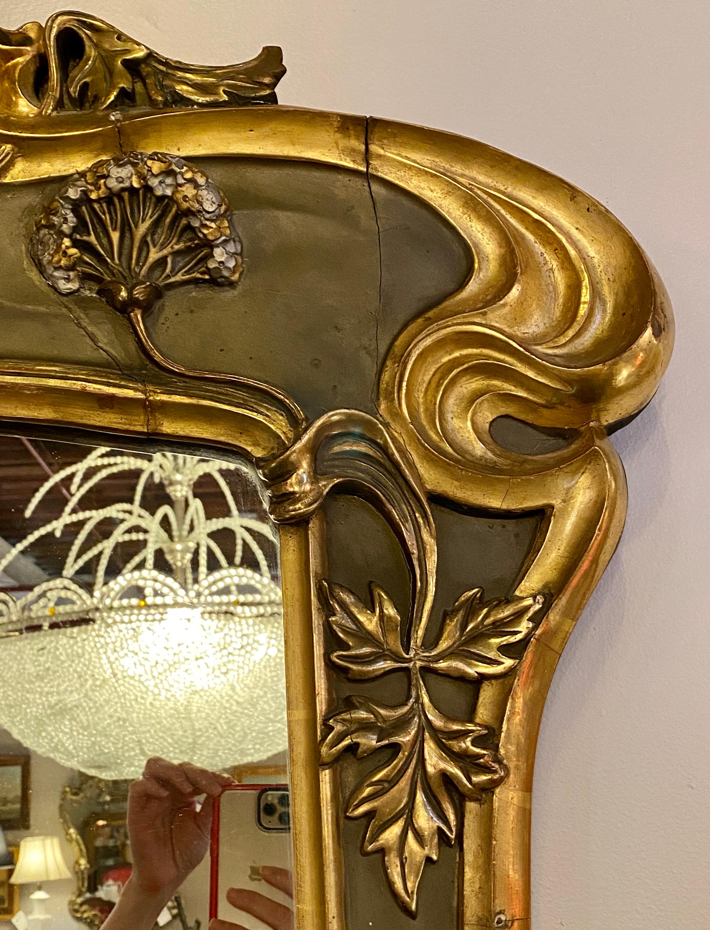 Belle époque style wall or over mantel mirror. This absolutely stunning Art Nouveau form wall mirror is paint and parcel-gilt decorated having rose, floral and leave carvings in gilt gold the like of which one rarely ever sees. The workmanship of