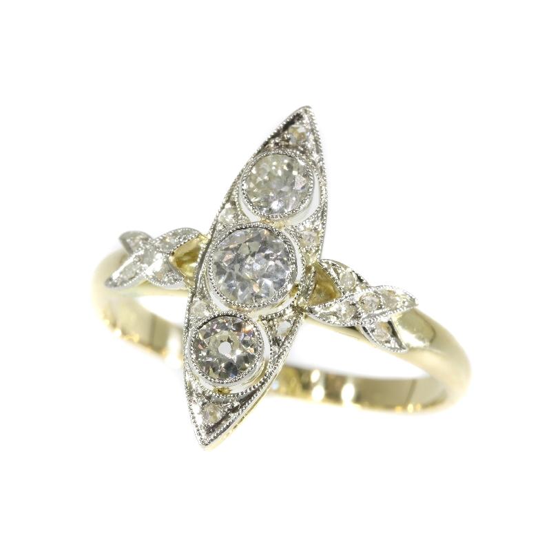 A Belle Epoque marquise engagement ring in 14 karat yellow and white gold set with a center old European cut diamond .30 carat, 2 old European cut diamonds totaling .34 carat (color and clarity: H/K, vs/i) and 16 rose cut diamonds. Length top of