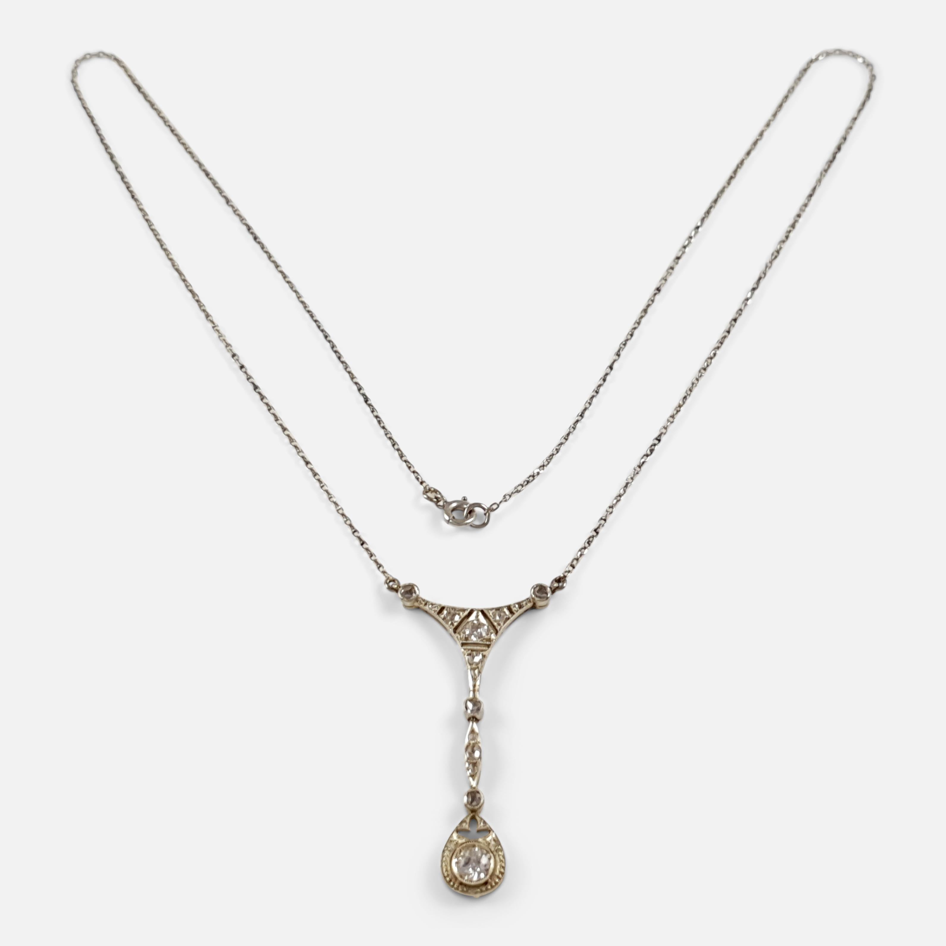 Description: - This is a fine antique Belle Epoque period white gold 0.575cts diamond pendant necklace, circa 1905. The articulated gold pendant is set with graduated circular-cut and rose-cut diamonds, on a fine link gold neck chain, and later roll