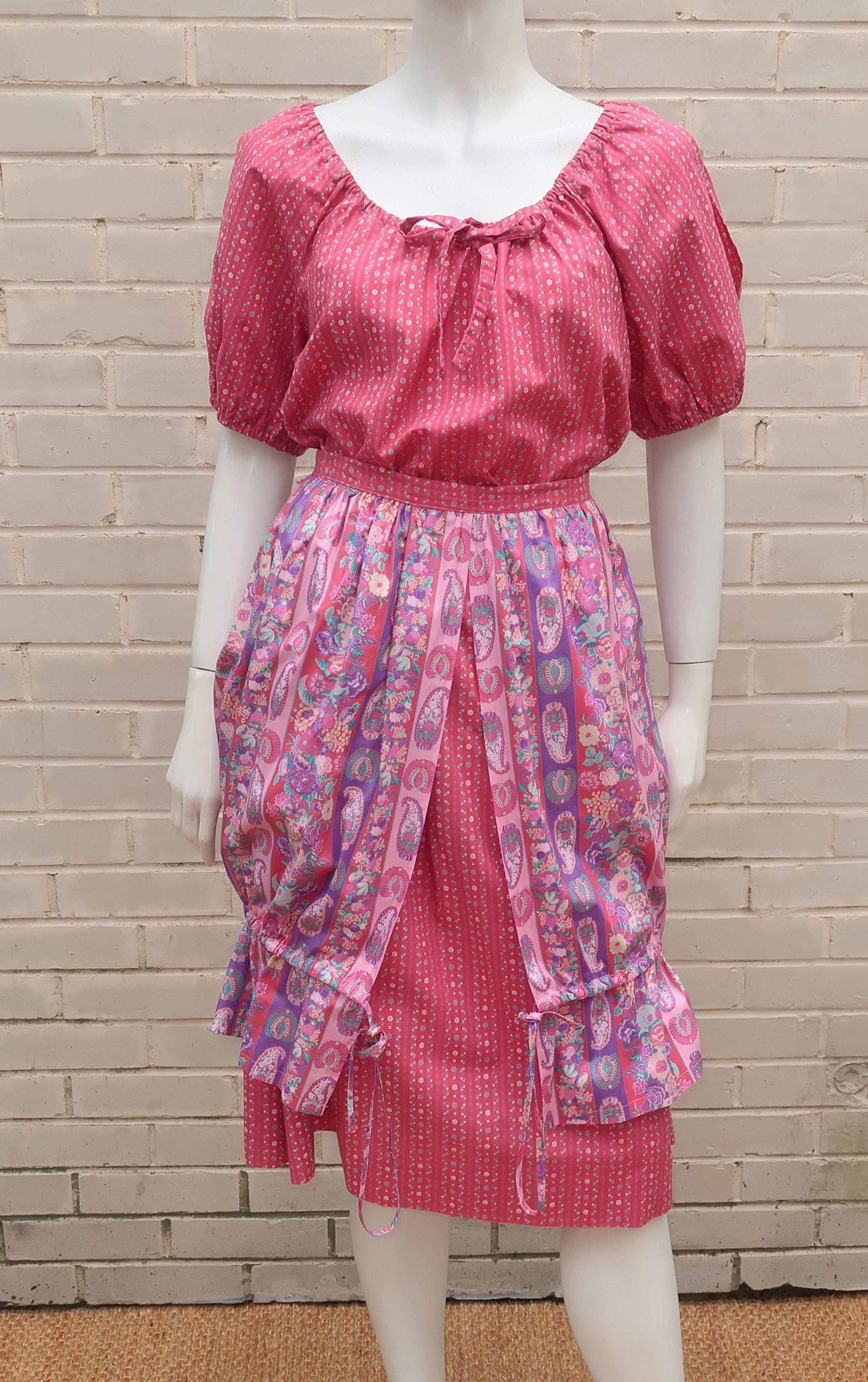 1970's floral cotton top and skirt by Jane Schaffhausen for her label Belle France.  The peasant style design includes a pullover top and two tiered skirt that zips at the side.  The top has vented puff sleeves and an elasticized collar with a faux