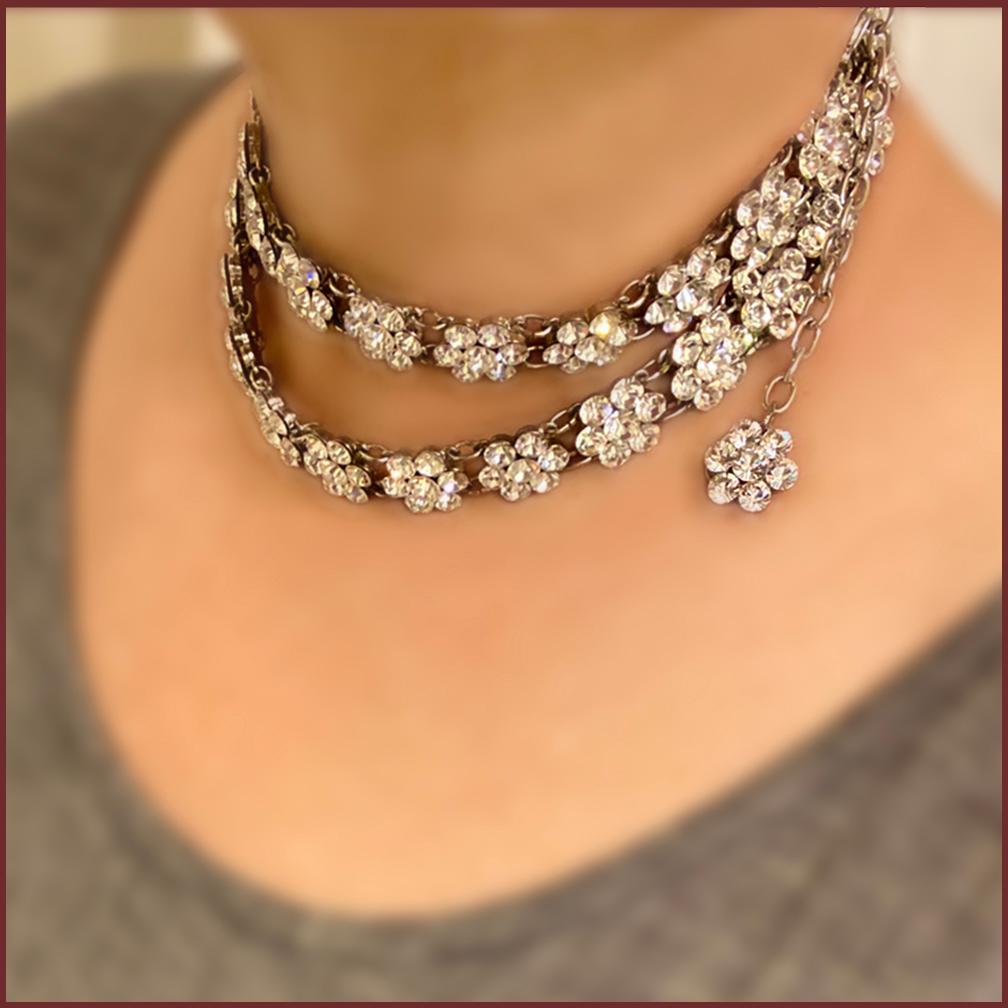 This is a Belle Paris crystal flower belt/necklace. This 29.5-33.5 inch double links with brilliant rhinestone flowers belt also can be wear as a long necklace or double up as a sexy choker. It would be a great holiday jewelry piece.

Our vintage
