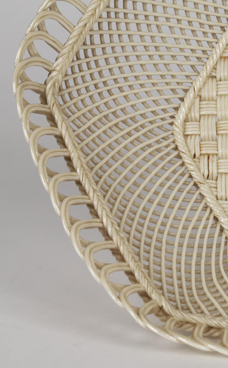 An exceptional and finely made Irish woven porcelain hexagonal shaped basket made by Belleek and dating from the 19th century. The stunning basket stands raised on a rope design foot rim with a recessed basket weave base. The side is made from
