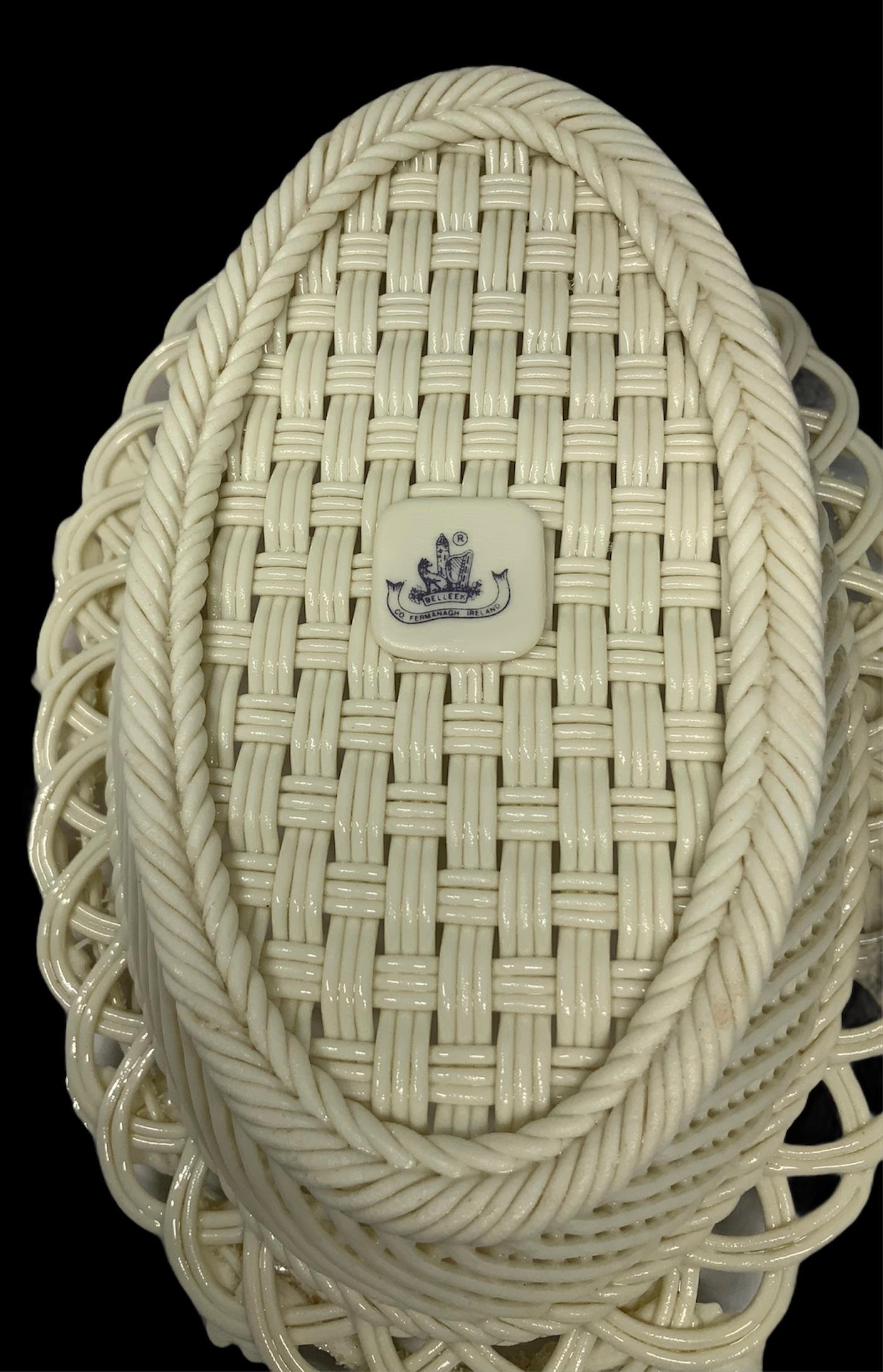 This is a delicate oval Porcelain woven basket decorated with 